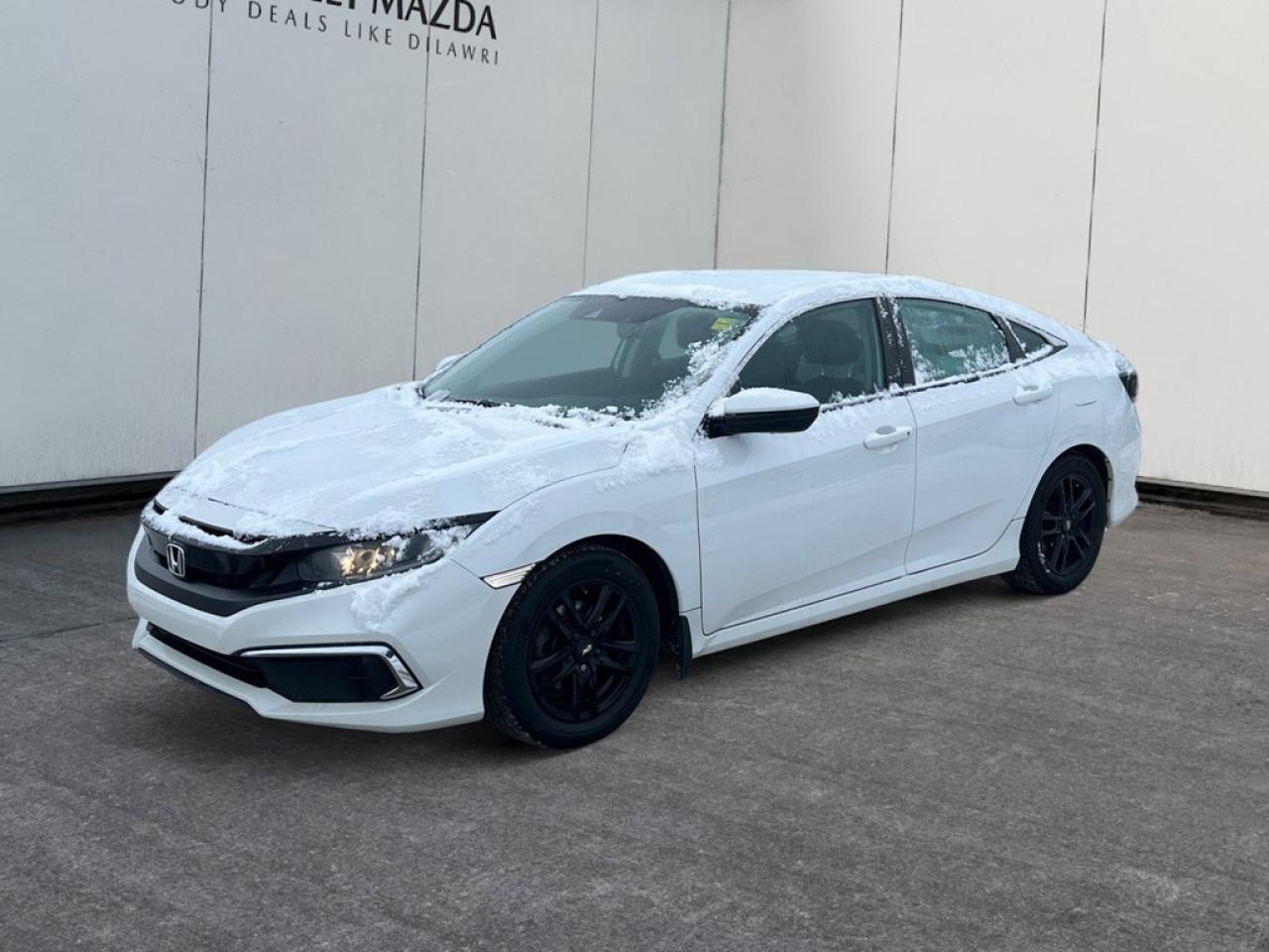 The immaculate 2020 Honda Civic Sedan LX in crisp white, coupled with a forward-thinking FWD drivetrain, presents an engaging driving experience thats both dynamic and reliable. With a responsive 2.0L 4-cylinder engine generating 158 horsepower at 6500 RPM, this manual sedan offers the thrill of precision handling for driving enthusiasts who value control and performance. The Civic Sedans sleek exterior lines are matched by its elegantly designed interior that boasts heated mirrors and front seats for those chilly Canadian mornings. Step inside to enjoy comfort in every ride with power windows and smart device integration that keeps you connected at all times. The cabin is thoughtfully furnished to provide ease and convenience with features like keyless entry and cruise control. Stay ahead with advanced technology including a backup camera and Bluetooth connection, ensuring top-notch connectivity and safety on the road. Safety and driver assistance come standard with lane assist, brake assist, and adaptive cruise control among others, making everyday drives more secure and enjoyable. This Civic is perfect for the modern driver who appreciates blend of technology, comfort, and performance at an excellent value. Ready to experience the harmonizing of innovation and tradition? Contact our dealership today for more information or to schedule a test drive!