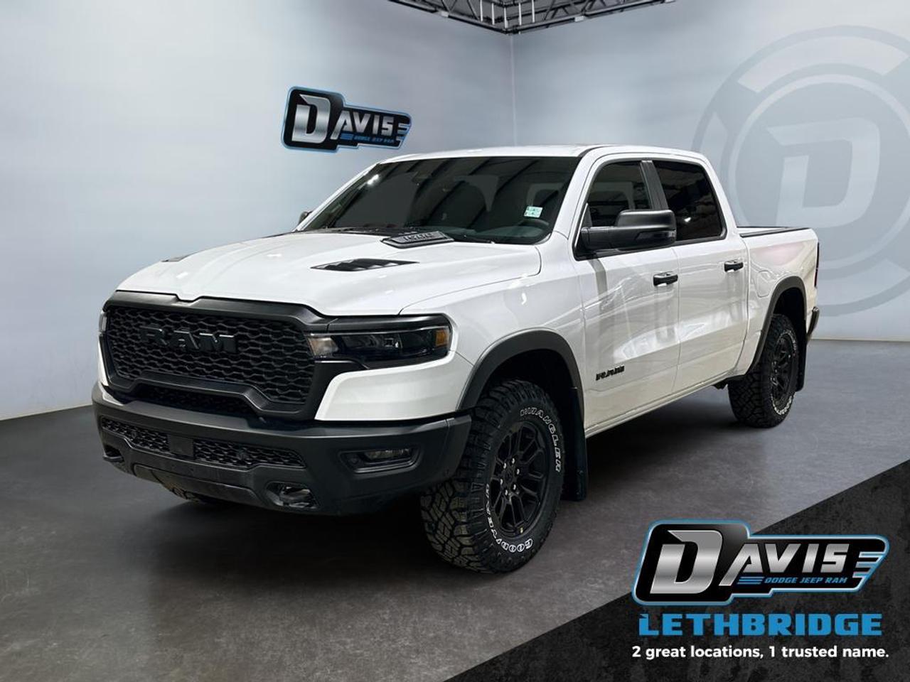 <b>E- Locker, Navigation, Apple CarPlay, Android Auto, Blind Spot Monitoring!<br /> <br /></b><br /> <br /> <br />The 2026 Ram 1500 Rebel in Bright White Clear Coat is built for off-road performance and bold style. Powered by a 3.0L I6 Twin-Turbo Hurricane engine with 8-speed automatic transmission and 4x4 drivetrain, it features off-road tuned shocks, E-Locker rear axle, 18-inch black wheels with all-terrain tires, dual black exhaust tips, and LED lighting for rugged capability.<br /><br />Inside, enjoy cloth/vinyl Rebel bucket seats, heated front seats, dual-zone climate control, 12-inch Uconnect touchscreen, Apple CarPlay/Android Auto, premium 9-speaker audio, and full-length upgraded floor console. Functional upgrades include under-seat storage, pickup box, capless fuel fill, and class IV receiver hitch.<br /><br />Safety and driver-assist tech include Adaptive Cruise Control with Stop & Go, Full-Speed Forward Collision Warning, Active Lane Management, Blind Spot & Cross Path Detection, ParkView rear camera, and Pedestrian Emergency Braking. The Ram 1500 Rebel blends off-road readiness, comfort, and advanced technology for adventure-seeking drivers.<br /> <br />To apply right now for financing use this link: <a href=https://lethbridge.davisdodge.ca/free-credit-check/ target=_blank rel=nofollow noopener noreferrer>https://lethbridge.davisdodge.ca/free-credit-check/</a><br /><br /> <br /><br />As a premier Chrysler, Dodge, Jeep and RAM dealership, Davis Dodge proudly offers an extensive selection of new and used vehicles to meet every drivers needs. Customers across Lethbridge, Fort Macleod, Taber, Claresholm, Coaldale, and beyond trust us for daily vehicle specials, certified service and parts, and a seamless online inventory experience. <br /><br /> With competitive financing options and expert support, we make car buying easy and enjoyable. <br /><br /> Ready to hit the road? Schedule your test drive today at Davis Dodge, your trusted Chrysler, Dodge, Jeep and RAM dealer in Lethbridge, Alberta.<br /><br /> Vehicle pricing offer shown expires 2026-04-30. <br /> Come by and check out our fleet of 70+ used cars and trucks and 110+ new cars and trucks for sale in Lethbridge. o~o