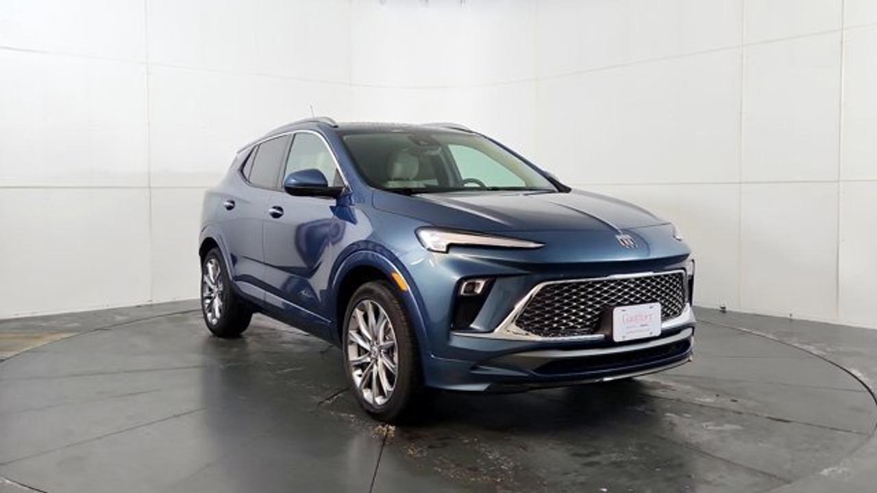 The 2026 Buick Encore GX Avenir elevates Buicks compact SUV to a new level of attainable luxury. Its exterior features distinctive Avenir styling---such as the Black Ice-finish grille, chrome beltline trim, clear-lens LED taillamps, and 19-inch Avenir Pearl Nickel alloy wheels---while the cabin includes perforated leather upholstery, heated power-adjustable front seats with driver memory, a heated steering wheel, a power-folding passenger seatback, auto-dimming rearview mirror, and a 120 V household-style outlet. Technology includes an 11-inch ultrawide touchscreen infotainment system paired with an 8-inch configurable driver display, wireless Apple CarPlay/Android Auto and Wi-Fi hotspot. This model also comes with a power moonroof, Rear Park Assist, HD Surround Vision and wireless charging.