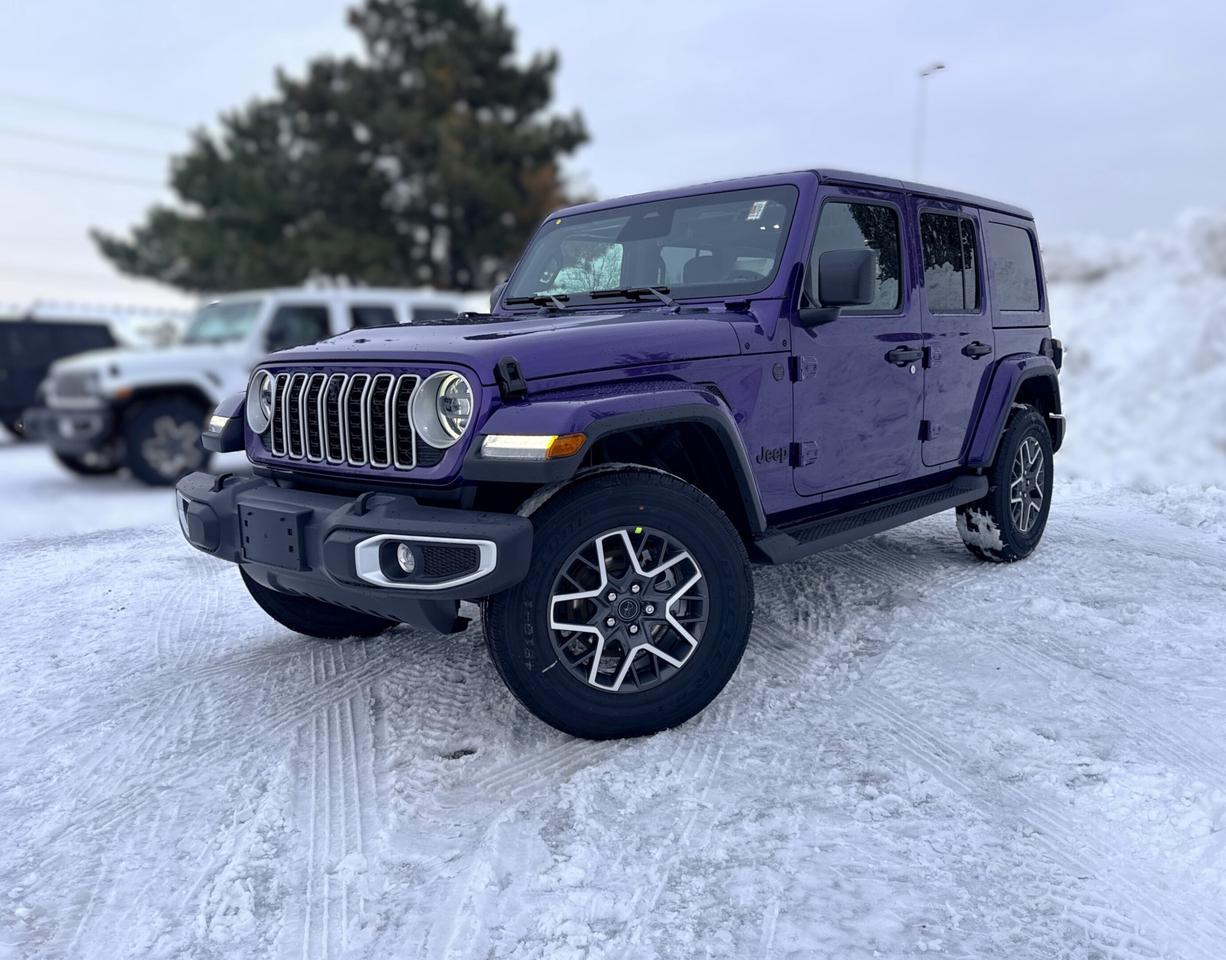 Our New 2026 Jeep Wrangler Sahara 4 Door 4X4 helps owners live the adventurous life in Reign (Purple)! Powered by a 3.6 Litre Pentastar V6 generating 285hp for an 8 Speed Automatic transmission thats eager for action. Dana axles and Command-Trac 4WD raise the bar for rugged performance, and this Four Wheel Drive SUV returns approximately 10.2L/100km on the highway with an iconic exterior design. Ready for open-air freedom with a removable top and doors, our Wrangler boasts LED lighting, fog lamps, a body-color sport bar, alloy wheels, and robust skid plates for added off-road protection.  Upscale details, including heated cloth front seats, a heated-wrapped steering wheel, automatic climate control, remote start, keyless access, pushbutton ignition, and 12V/115V power outlets, add extra comfort to our Sahara cabin. Our Wrangler also impresses in the infotainment department, thanks to a 12.3-inch touchscreen, a 7-inch driver display, WiFi compatibility, Apple CarPlay&reg;, Android Auto&reg;, Bluetooth&reg;, eight-speaker audio, and the trail-friendly tech benefits of Off-Road Info Pages. Its a comfortable cockpit for taking command!  Smart owners demand intelligent safety, and Jeep delivers with automatic braking, adaptive cruise control, forward collision warning, a rearview camera, hill start assist, trailer sway damping, and more. The world awaits, and our Wrangler Sahara is ready to go! Save this Page and Call for Availability. We Know You Will Enjoy Your Test Drive Towards Ownership!