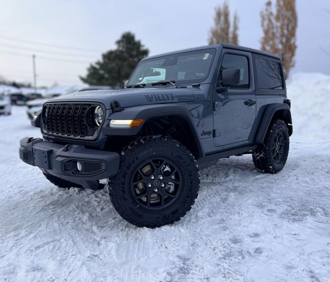Our New 2026 Jeep Wrangler Willys 2 Door 4X4 with the Convenience Pack in Anvil rides with renowned capability that true adventurers love! Driven by a TurboCharged 2.0 Litre 4 Cylinder supplying 270hp to an 8 Speed Automatic transmission with an Off-Road Plus mode for enhanced trail performance. Dana axles and an electronic locking rear differential help you conquer almost any conditions, and this Four Wheel Drive SUV returns approximately 10.2L/100km on the highway. Eye-catching Willys hood graphics help our Wrangler grab attention with LED lighting, fog lamps, alloy wheels, fender flares, a sport bar, and a fantastic open-air driving experience when you drop the 3-piece black Freedom top, fold down the Gorilla Glass windshield, and remove the doors!  Thanks to our Convenience Pack, you can feel good with the top up or down in our Willys cabin. It bundles heated cloth seats, a heated-wrapped steering wheel, automatic climate control, remote start, and a 7-inch driver display for better driving. Uconnect&reg; technology powers your infotainment system to enjoy a 12.3-inch touchscreen, 3.5-inch driver display, Apple CarPlay&reg;, WiFi compatibility, Android Auto&reg;, Bluetooth&reg;, and an eight-speaker audio system.  Stay safe as you dominate your days, knowing Jeep has your back with automatic braking, adaptive cruise control, a rearview camera, forward collision warning, trailer sway damping, hill start assistance, and more. The world awaits, and our Wrangler Willys is ready to go! Save this Page and Call for Availability. We Know You Will Enjoy Your Test Drive Towards Ownership!