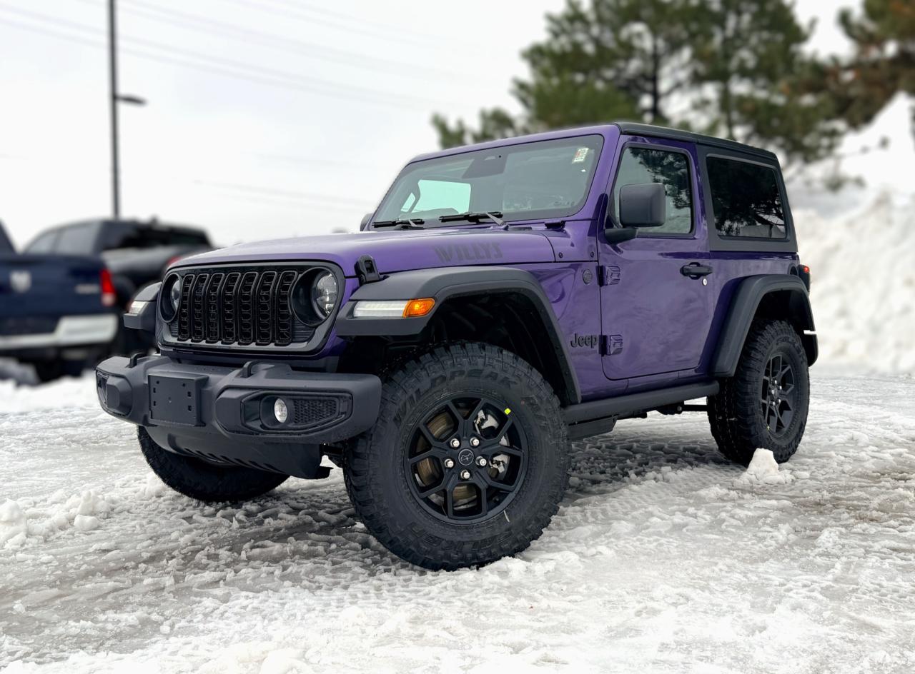 Our New 2026 Jeep Wrangler Willys 2 Door 4X4 with the Convenience Package in Reign (Purple) combines classic Jeep character with trail-ready confidence, making it the perfect companion for drivers who crave adventure. Driven by a TurboCharged 2.0 Litre 4 Cylinder supplying 270hp to an 8 Speed Automatic transmission with an Off-Road Plus mode for enhanced trail performance. Dana axles and an electronic locking rear differential help you conquer almost any conditions, and this Four Wheel Drive SUV returns approximately 10.2L/100km on the highway. Eye-catching Willys hood graphics help our Wrangler grab attention with LED lighting, fog lamps, alloy wheels, fender flares, a sport bar, and a fantastic open-air driving experience when you drop the top, fold down the Gorilla Glass windshield, and remove the doors!  Thanks to our Convenience Pack, you can feel good with the top up or down in our Willys cabin. It bundles heated cloth seats, a heated-wrapped steering wheel, automatic climate control, remote start, and a 7-inch driver display for better driving. Uconnect&reg; technology powers your infotainment system to enjoy a 12.3-inch touchscreen, 3.5-inch driver display, Apple CarPlay&reg;, WiFi compatibility, Android Auto&reg;, Bluetooth&reg;, and an eight-speaker audio system.  Stay safe as you dominate your days, knowing Jeep has your back with automatic braking, adaptive cruise control, a rearview camera, forward collision warning, trailer sway damping, hill start assistance, and more. The world awaits, and our Wrangler Willys is ready to go! Save this Page and Call for Availability. We Know You Will Enjoy Your Test Drive Towards Ownership!