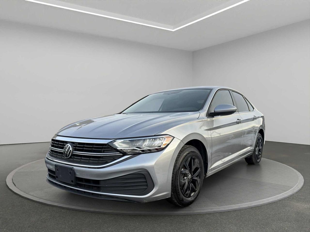 <h2>2023 Volkswagen Jetta</h2><p><br></p><p><strong>Now Available at Topnotch Auto Sales Inc</strong></p><p><br></p><p>Discover the exceptional blend of German precision, contemporary styling, and dependable everyday performance with the 2023 Volkswagen Jetta. This sought-after sedan is celebrated for its refined driving dynamics, impressive fuel efficiency, and an array of thoughtful features designed to enhance your daily commute. With a distinctive exterior, elegant lines, and a well-appointed interior, the Jetta stands out as an intelligent option for commuters, students, and anyone seeking a reliable vehicle with a touch of sophistication. Experience the harmony of comfort and practicality in one of Volkswagens most acclaimed models.</p><p><br></p><p><br></p><p><br></p><p><br></p><h2>Performance & Capability</h2><p><br></p><p>The 2023 Volkswagen Jetta features a responsive and efficient powertrain, delivering smooth acceleration and precise control through its advanced automatic transmission. Designed to provide an outstanding balance of power and efficiency, the Jettas finely tuned suspension system ensures a composed ride across both city streets and highways. The exceptional fuel economy means youll enjoy fewer stops at the pump without compromising on driving pleasure or capability, making every journey both economical and enjoyable.</p><p><br></p><p><br></p><p><br></p><p><br></p><h2>Interior Comfort & Features</h2><p><br></p><p>Slide into a spacious, thoughtfully designed cabin where comfort and convenience are at the forefront. Notable interior highlights include:</p><p><br></p><ul><li><br></li><li>Ergonomically designed seating for up to five adults, ensuring comfort on short trips or long drives</li><li><br></li><li>Power-adjustable windows, door locks, and side mirrors for ultimate convenience</li><li><br></li><li>Dual-zone automatic climate control for customized comfort across the cabin</li><li><br></li><li>Intuitive dashboard layout and controls for effortless use</li><li><br></li><li>Generous trunk space complemented by versatile cargo solutions to fit your lifestyle</li><li><br></li></ul><p><br></p><p>The 2023 Jetta merges everyday practicality with premium finishes and quality materials, making every drive relaxed and enjoyable.</p><p><br></p><p><br></p><p><br></p><p><br></p><h2>Technology & Connectivity</h2><p><br></p><p>Enjoy the latest in automotive technology with advanced connectivity features, including:</p><p><br></p><ul><li><br></li><li>High-resolution touchscreen infotainment system for easy control of entertainment and navigation</li><li><br></li><li>Seamless Apple CarPlay® and Android Auto integration</li><li><br></li><li>Bluetooth hands-free calling with wireless audio streaming</li><li><br></li><li>Convenient USB charging ports to keep devices powered on the go</li><li><br></li><li>Steering wheel-mounted controls for effortless access to your favourite functions</li><li><br></li><li>Premium audio system delivering impressive sound quality for every journey</li><li><br></li></ul><p><br></p><p>The Jetta keeps you connected, informed, and entertained wherever the road takes you.</p><p><br></p><p><br></p><p><br></p><p><br></p><h2>Safety & Peace of Mind</h2><p><br></p><p>Engineered for confidence and security, the 2023 Volkswagen Jetta is equipped with a comprehensive suite of safety innovations:</p><p><br></p><ul><li><br></li><li>Rearview camera enhances safety and simplifies parking and reversing</li><li><br></li><li>Advanced traction and electronic stability control for maximum control in all conditions</li><li><br></li><li>Anti-lock braking system (ABS) for safer, more controlled stops</li><li><br></li><li>Multiple strategically placed airbags to protect occupants in every seat</li><li><br></li><li>Tire pressure monitoring system to ensure optimal safety and performance</li><li><br></li></ul><p><br></p><p>Drive with peace of mind knowing your well-being is a top priority in every aspect of the Jettas design.</p><p><br></p><p><br></p><p><br></p><p><br></p><h2>Vehicle Condition</h2><p><br></p><p>This 2023 Volkswagen Jetta has been meticulously maintained and is in outstanding, non-smoking condition throughout. Professionally detailed and thoroughly inspected, this vehicle demonstrates pride of ownership and is ready to deliver years of reliable motoring to its next owner.</p><p><br></p><p><br></p><p><br></p><p><br></p><h2>Why Choose Topnotch Auto Sales?</h2><p><br></p><p>At Topnotch Auto Sales Inc, we are dedicated to providing only the highest quality pre-owned vehicles and unparalleled customer service. Our knowledgeable team ensures your vehicle purchasing process is smooth, transparent, and tailored to your needs, making your satisfaction our priority.</p><p><br></p><p><br></p><p><br></p><p><br></p><h2>Flexible Financing Solutions</h2><p><br></p><p>No matter your credit historyexcellent, new, or challengedwe provide fast, hassle-free approvals for <strong>all credit situations</strong>. Take advantage of same-day approvals and low down payment programs, designed to get you on the road quickly and securely.</p><p><br></p><p><br></p><p><br></p><p><br></p><h2>Certification Option</h2><p><br></p><p>For just <strong>$799</strong>, you can certify this 2023 Volkswagen Jetta to ensure it fully meets all Ontario safety standards, offering additional security and peace of mind for your purchase.</p><p><br></p><p><br></p><p><br></p><p><br></p><h2>OMVIC Compliance</h2><p><br></p><p><strong>Important:</strong> Uncertified vehicles are sold asis and must be certified for road use in accordance with OMVIC regulations. Our team is here to help guide you through the certification process for a smooth transition to ownership.</p><p><br></p><p><br></p><p><br></p><p><br></p><p>With more than <strong>14 years of automotive expertise</strong>, Topnotch Auto Sales Inc has established a reputation for honesty, quality vehicles, and an unwavering commitment to customer satisfaction. We are proud to be your trusted destination for a stress-free car shopping experience in <strong>{location}</strong>.</p><p><br></p><p><br></p><p><br></p><p> <strong>Visit Us At:</strong></p><p><br></p><p>5455 Steeles Ave W, North York, ON M9L 1S7</p><p><br></p><p> <strong>Call or Text:</strong></p><p><br></p><p>416-879-7113</p>