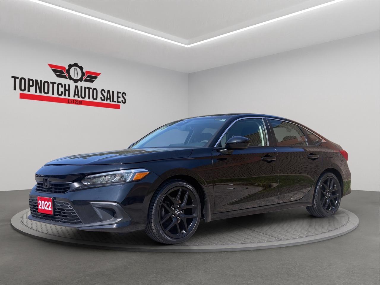 <p style=margin: 0.0px 0.0px 0.0px 0.0px; font: 13.0px Helvetica Neue><strong>2022 Honda Civic LX CVT</strong><br><strong>Now Available at Topnotch Auto Sales Inc</strong></p><p style=margin: 0.0px 0.0px 0.0px 0.0px; font: 13.0px Helvetica Neue>Experience the perfect combination of reliability, fuel efficiency, and modern technology with the <strong>2022 Honda Civic LX CVT</strong>. Known for its exceptional driving dynamics, impressive fuel economy, and comfortable interior, this stylish sedan is ideal for commuting, family driving, or weekend road trips.</p><p style=margin: 0.0px 0.0px 2.0px 0.0px; font: 16.0px Helvetica Neue><strong>Performance & Efficiency</strong></p><p style=margin: 0.0px 0.0px 0.0px 0.0px; font: 13.0px Helvetica Neue>Powered by a responsive <strong>2.0L 4-cylinder engine</strong> paired with a smooth <strong>Continuously Variable Transmission (CVT)</strong>, the Honda Civic delivers an enjoyable driving experience with excellent fuel economy.</p><p style=margin: 0.0px 0.0px 0.0px 0.0px; font: 13.0px Helvetica Neue><strong>Performance Highlights:</strong></p><ul style=list-style-type: disc><li style=margin: 0.0px 0.0px 0.0px 0.0px; font: 13.0px Helvetica Neue>2.0L 4-Cylinder Engine</li><li style=margin: 0.0px 0.0px 0.0px 0.0px; font: 13.0px Helvetica Neue>Automatic CVT Transmission</li><li style=margin: 0.0px 0.0px 0.0px 0.0px; font: 13.0px Helvetica Neue>Front-Wheel Drive (FWD)</li><li style=margin: 0.0px 0.0px 0.0px 0.0px; font: 13.0px Helvetica Neue>Smooth and responsive handling</li><li style=margin: 0.0px 0.0px 0.0px 0.0px; font: 13.0px Helvetica Neue>Excellent fuel efficiency</li><li style=margin: 0.0px 0.0px 0.0px 0.0px; font: 13.0px Helvetica Neue>Comfortable and confident everyday driving</li></ul><p style=margin: 0.0px 0.0px 0.0px 0.0px; font: 13.0px Helvetica Neue><strong>Fuel Economy:</strong></p><ul style=list-style-type: disc><li style=margin: 0.0px 0.0px 0.0px 0.0px; font: 13.0px Helvetica Neue>City: <strong>7.7 L/100 km</strong></li><li style=margin: 0.0px 0.0px 0.0px 0.0px; font: 13.0px Helvetica Neue>Highway: <strong>6.0 L/100 km</strong></li></ul><p style=margin: 0.0px 0.0px 0.0px 0.0px; font: 13.0px Helvetica Neue>Whether youre commuting to work or taking a weekend getaway, the Honda Civic helps you save at the pump while delivering dependable performance.</p><p style=margin: 0.0px 0.0px 2.0px 0.0px; font: 16.0px Helvetica Neue><strong>Interior Comfort & Features</strong></p><p style=margin: 0.0px 0.0px 0.0px 0.0px; font: 13.0px Helvetica Neue>Enjoy a spacious and thoughtfully designed cabin built for comfort and convenience.</p><p style=margin: 0.0px 0.0px 0.0px 0.0px; font: 13.0px Helvetica Neue><strong>Interior Features Include:</strong></p><ul style=list-style-type: disc><li style=margin: 0.0px 0.0px 0.0px 0.0px; font: 13.0px Helvetica Neue>Comfortable seating for up to five passengers</li><li style=margin: 0.0px 0.0px 0.0px 0.0px; font: 13.0px Helvetica Neue>Premium cloth seating</li><li style=margin: 0.0px 0.0px 0.0px 0.0px; font: 13.0px Helvetica Neue>Air conditioning</li><li style=margin: 0.0px 0.0px 0.0px 0.0px; font: 13.0px Helvetica Neue>Power windows</li><li style=margin: 0.0px 0.0px 0.0px 0.0px; font: 13.0px Helvetica Neue>Power door locks</li><li style=margin: 0.0px 0.0px 0.0px 0.0px; font: 13.0px Helvetica Neue>Tilt and telescopic steering wheel</li><li style=margin: 0.0px 0.0px 0.0px 0.0px; font: 13.0px Helvetica Neue>Cruise control</li><li style=margin: 0.0px 0.0px 0.0px 0.0px; font: 13.0px Helvetica Neue>Spacious trunk</li><li style=margin: 0.0px 0.0px 0.0px 0.0px; font: 13.0px Helvetica Neue>Ample cabin storage</li></ul><p style=margin: 0.0px 0.0px 0.0px 0.0px; font: 13.0px Helvetica Neue>The Civic offers a refined interior with plenty of room for passengers and everyday cargo.</p><p style=margin: 0.0px 0.0px 2.0px 0.0px; font: 16.0px Helvetica Neue><strong>Technology & Connectivity</strong></p><p style=margin: 0.0px 0.0px 0.0px 0.0px; font: 13.0px Helvetica Neue>Stay connected wherever the road takes you.</p><p style=margin: 0.0px 0.0px 0.0px 0.0px; font: 13.0px Helvetica Neue><strong>Technology Features:</strong></p><ul style=list-style-type: disc><li style=margin: 0.0px 0.0px 0.0px 0.0px; font: 13.0px Helvetica Neue>Bluetooth® hands-free calling and audio streaming</li><li style=margin: 0.0px 0.0px 0.0px 0.0px; font: 13.0px Helvetica Neue>AM/FM audio system</li><li style=margin: 0.0px 0.0px 0.0px 0.0px; font: 13.0px Helvetica Neue>USB connectivity</li><li style=margin: 0.0px 0.0px 0.0px 0.0px; font: 13.0px Helvetica Neue>Steering-wheel-mounted audio controls</li><li style=margin: 0.0px 0.0px 0.0px 0.0px; font: 13.0px Helvetica Neue>Multi-function driver information display</li><li style=margin: 0.0px 0.0px 0.0px 0.0px; font: 13.0px Helvetica Neue>Apple CarPlay® and Android Auto compatibility</li><li style=margin: 0.0px 0.0px 0.0px 0.0px; font: 13.0px Helvetica Neue>12V power outlet</li></ul><p style=margin: 0.0px 0.0px 0.0px 0.0px; font: 13.0px Helvetica Neue>Everything you need for a connected and enjoyable driving experience.</p><p style=margin: 0.0px 0.0px 2.0px 0.0px; font: 16.0px Helvetica Neue><strong>Safety & Driver Assistance</strong></p><p style=margin: 0.0px 0.0px 0.0px 0.0px; font: 13.0px Helvetica Neue>The <strong>2022 Honda Civic LX</strong> comes equipped with advanced safety technologies to help provide added confidence on every drive.</p><p style=margin: 0.0px 0.0px 0.0px 0.0px; font: 13.0px Helvetica Neue><strong>Safety Features Include:</strong></p><ul style=list-style-type: disc><li style=margin: 0.0px 0.0px 0.0px 0.0px; font: 13.0px Helvetica Neue>Anti-lock Braking System (ABS)</li><li style=margin: 0.0px 0.0px 0.0px 0.0px; font: 13.0px Helvetica Neue>Electronic Stability Control (ESC)</li><li style=margin: 0.0px 0.0px 0.0px 0.0px; font: 13.0px Helvetica Neue>Traction Control System</li><li style=margin: 0.0px 0.0px 0.0px 0.0px; font: 13.0px Helvetica Neue>Brake Assist</li><li style=margin: 0.0px 0.0px 0.0px 0.0px; font: 13.0px Helvetica Neue>Tire Pressure Monitoring System (TPMS)</li><li style=margin: 0.0px 0.0px 0.0px 0.0px; font: 13.0px Helvetica Neue>Multiple airbags</li><li style=margin: 0.0px 0.0px 0.0px 0.0px; font: 13.0px Helvetica Neue>Rearview camera</li><li style=margin: 0.0px 0.0px 0.0px 0.0px; font: 13.0px Helvetica Neue>Lane Keeping Assist System</li><li style=margin: 0.0px 0.0px 0.0px 0.0px; font: 13.0px Helvetica Neue>Collision Mitigation Braking System</li><li style=margin: 0.0px 0.0px 0.0px 0.0px; font: 13.0px Helvetica Neue>Adaptive Cruise Control</li><li style=margin: 0.0px 0.0px 0.0px 0.0px; font: 13.0px Helvetica Neue>Road Departure Mitigation</li><li style=margin: 0.0px 0.0px 0.0px 0.0px; font: 13.0px Helvetica Neue>LATCH child seat anchors</li></ul><p style=margin: 0.0px 0.0px 0.0px 0.0px; font: 13.0px Helvetica Neue>Drive with confidence knowing the Civic is equipped with Hondas advanced safety technologies.</p><p style=margin: 0.0px 0.0px 2.0px 0.0px; font: 16.0px Helvetica Neue><strong>Vehicle Condition</strong></p><p style=margin: 0.0px 0.0px 0.0px 0.0px; font: 13.0px Helvetica Neue>This <strong>2022 Honda Civic LX CVT</strong> has been well maintained and is ready for its next owner.</p><p style=margin: 0.0px 0.0px 0.0px 0.0px; font: 13.0px Helvetica Neue><strong>Vehicle Information:</strong></p><ul style=list-style-type: disc><li style=margin: 0.0px 0.0px 0.0px 0.0px; font: 13.0px Helvetica Neue><strong>Price:</strong> $20,950</li><li style=margin: 0.0px 0.0px 0.0px 0.0px; font: 13.0px Helvetica Neue><strong>Odometer:</strong> 89,534 KM</li><li style=margin: 0.0px 0.0px 0.0px 0.0px; font: 13.0px Helvetica Neue><strong>Stock Number:</strong> 104960</li><li style=margin: 0.0px 0.0px 0.0px 0.0px; font: 13.0px Helvetica Neue><strong>VIN:</strong> 2HGFE2F27NH104960</li><li style=margin: 0.0px 0.0px 0.0px 0.0px; font: 13.0px Helvetica Neue><strong>Exterior Color:</strong> Black</li><li style=margin: 0.0px 0.0px 0.0px 0.0px; font: 13.0px Helvetica Neue><strong>Interior Color:</strong> Black</li><li style=margin: 0.0px 0.0px 0.0px 0.0px; font: 13.0px Helvetica Neue><strong>Body Style:</strong> Sedan</li><li style=margin: 0.0px 0.0px 0.0px 0.0px; font: 13.0px Helvetica Neue><strong>Doors:</strong> 4</li><li style=margin: 0.0px 0.0px 0.0px 0.0px; font: 13.0px Helvetica Neue><strong>Passengers:</strong> 5</li></ul><p style=margin: 0.0px 0.0px 2.0px 0.0px; font: 16.0px Helvetica Neue><strong>Topnotch Auto Sales  Your Trusted Source for Quality Pre-Owned Vehicles</strong></p><p style=margin: 0.0px 0.0px 0.0px 0.0px; font: 13.0px Helvetica Neue>At Topnotch Auto Sales Inc, we are committed to offering quality vehicles, exceptional customer service, and flexible financing solutions tailored to your needs.</p><p style=margin: 0.0px 0.0px 2.0px 0.0px; font: 16.0px Helvetica Neue><strong>Financing Available</strong></p><p style=margin: 0.0px 0.0px 0.0px 0.0px; font: 13.0px Helvetica Neue>We work with all credit situations:</p><ul style=list-style-type: disc><li style=margin: 0.0px 0.0px 0.0px 0.0px; font: 13.0px Helvetica Neue>Good Credit</li><li style=margin: 0.0px 0.0px 0.0px 0.0px; font: 13.0px Helvetica Neue>Bad Credit</li><li style=margin: 0.0px 0.0px 0.0px 0.0px; font: 13.0px Helvetica Neue>No Credit</li><li style=margin: 0.0px 0.0px 0.0px 0.0px; font: 13.0px Helvetica Neue>New to Canada</li><li style=margin: 0.0px 0.0px 0.0px 0.0px; font: 13.0px Helvetica Neue>Self-Employed</li></ul><p style=margin: 0.0px 0.0px 0.0px 0.0px; font: 13.0px Helvetica Neue>Fast approvals and low down payment options available.</p><p style=margin: 0.0px 0.0px 2.0px 0.0px; font: 16.0px Helvetica Neue><strong>Certification Available</strong></p><p style=margin: 0.0px 0.0px 0.0px 0.0px; font: 13.0px Helvetica Neue>Vehicle can be certified for only <strong>$799</strong>.</p><p style=margin: 0.0px 0.0px 0.0px 0.0px; font: 13.0px Helvetica Neue>Certification includes a comprehensive inspection to meet Ontario safety standards.</p><p style=margin: 0.0px 0.0px 2.0px 0.0px; font: 16.0px Helvetica Neue><strong>OMVIC Disclosure</strong></p><p style=margin: 0.0px 0.0px 0.0px 0.0px; font: 13.0px Helvetica Neue>As per OMVIC regulations, this vehicle is currently being sold as<span id=jodit-selection_marker_1787409366442_40740089612011265 data-jodit-selection_marker=start style=line-height: 0; display: none;></span>is and is not certified unless otherwise stated. Certification is available at an additional cost.</p><p style=margin: 0.0px 0.0px 0.0px 0.0px; font: 13.0px Helvetica Neue>With over 14 years of experience, Topnotch Auto Sales Inc is dedicated to providing a smooth, transparent, and stress-free car-buying experience.</p><p style=margin: 0.0px 0.0px 0.0px 0.0px; font: 13.0px Helvetica Neue><strong>Price: $20,950</strong></p><p style=margin: 0.0px 0.0px 0.0px 0.0px; font: 13.0px Helvetica Neue> <strong>Visit Us:</strong><br>5455 Steeles Ave W, North York, ON M9L 1S7</p><p style=margin: 0.0px 0.0px 0.0px 0.0px; font: 13.0px Helvetica Neue><span style=font: 13.0px .Apple Color Emoji UI></span> <strong>Call or Text:</strong><br>416-879-7113</p><br class=Apple-interchange-newline>