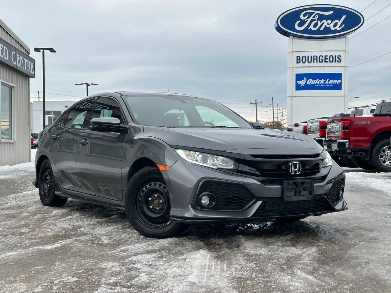 <p>Experience the refined driving dynamics of the 2017 Honda Civic Hatchback Sport in a sophisticated Gray finish with a Front-Wheel Drive configuration. This manual transmission model is designed for those who appreciate precision handling and the tactile satisfaction of a stick shift.</p><p>The exterior of this Civic is enhanced by sleek alloy wheels and modern styling that make a statement on every drive. Step inside to a comfortable Black interior equipped with a leather steering wheel and heated front seats that cater to your comfort. Enjoy extra convenience with features like power windows and keyless entry, while the sunroof offers an open-air experience.</p><p>Tech-savvy drivers will appreciate the seamless smart device integration and Bluetooth connectivity, allowing you to stay connected on the go. Safety features such as a backup camera, brake assist, and heated mirrors are designed to offer peace of mind, while cruising in comfort with the cruise control setting.</p><p>This Honda Civic Hatchback Sport Manual is perfect for those who value a harmonious blend of performance, technology, and style. Contact us today to learn more about this exceptional vehicle and schedule a test drive. Your next adventure awaits!</p> <p><strong>Why Choose the Bourgeois Auto Group?</strong></p><p>For 80 years, Bourgeois Auto Group has been delivering exceptional automotive experiences. Our factor trained teams work to ensure you receive the shopping experience you deserve; whether you're looking for a new or new-to-you vehicle.</p><p>Shop 24/7 with our online showroom and chat service, ensuring convenience every step of the way. No hidden fees, full disclosure, and every pre-owned vehicle comes with a Carfax® report for peace of mind.</p><p>We offer a wide selection of pre-owned vehicles, all competitively priced using real-time market data. Get the best deal on your purchase and trade-in with our free Live Market Analysis report.</p><p>Looking to sell your car? We buy any make or modelno purchase required. Our simple to use online trade valuation tool will provide you with a clear, transparent selling experience whether you buy our car or not.</p><p>Backed by hundreds dedicated employees across 4 convenient locations, were here to meet all your automotive needs. Visit us in Midland or Parry Sound and explore our inventory or schedule your next service today.</p> <p><strong>Financing Your Next Vehicle with Bourgeois Motors Ford in Midland:</strong></p><p>At Bourgeois Motors Ford, we make financing your next vehicle simple and stress-free! Our team works with trusted lenders to find flexible options tailored to your budget. Drive away with confidenceapply today!</p><p>Take advantage of our online pre-qualification tool, backed by Equifax and TD Bank to find the payment that works for you. Simply <a href=https://www.bourgeoismotors.com/free-credit-check/ rel=nofollow><strong>CLICK HERE</strong></a><strong> </strong>to use our secure online credit tool with no impact to your credit.</p>