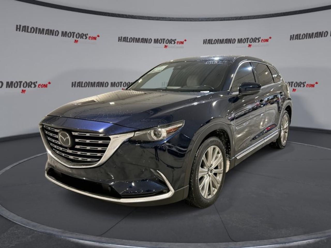 // SINGLE OWNER! //Meet our used 2022 Mazda CX-9 Signature AWD | One Owner | 360 Camera | Sunroof, offered by Haldimand Motors Ltd. in Cayuga. Finished in a deep blue and showing 107,950 km, this 4-door SUV brings premium road manners, confident all-wheel drive traction, and family-ready space in one refined package.Under the hood, this 2022 Mazda CX-9 Signature AWD | One Owner | 360 Camera | Sunroof uses a 2.5 L gas engine paired with a smooth 6-speed automatic transmission. Its built for everyday comfort, yet it stays composed on the highway and secure in changing Ontario weather, thanks to stability control and a limited slip differential.FEATURES OF THE CX-9 Signature AWD | One Owner | 360 Camera | SunroofSignature trim with premium cabin touches360-degree camera for parking confidencePower sunroof for open-air drivesHead-up display keeps eyes forwardADVANCED SAFETY FEATURESAnti-lock braking system helps controlled stopsStability control supports confident corneringBlind spot monitor for safer lane changesLane departure warning adds extra awarenessPERFORMANCE AND EFFICIENCY2.5 L gas engine, smooth power6-speed automatic with dual shift modeAll-wheel drive for year-round tractionAdaptive cruise control eases highway drivingCOMFORT AND CONVENIENCEDual-zone automatic climate control keeps comfort balancedRear climate control for second-row comfortHeated front seats for cold morningsHeated rear seats for winter passengersTECHNONOLGY AND CONNECTIVITYNavigation system helps plan every routeApple CarPlay and Android Auto integrationBluetooth integration for hands-free callingSteering wheel audio controls keep focusCARGO SPACEPower liftgate for easy loadingRemote trunk release adds quick accessPractical SUV cargo area for errandsSpare tire included for added preparednessWHAT OTHER OWNERS LIKEQuiet ride quality on longer tripsStrong safety tech and driver aidsEasy-to-use infotainment and phone pairingConfident all-wheel drive in bad weatherThis SUV is well equipped for daily commuting and weekend travel. Youll also appreciate the convenience details like push button start, power windows, power steering, power mirrors with heated mirrors, retractable mirrors, tinted windows, and automatic door locks. For visibility, it includes LED headlamps, automatic headlights, fog lights, turn signal mirrors, and a rear window defroster.For added peace of mind on the road, this Mazda includes a driver airbag, passenger airbag with passenger airbag sensor, side impact airbags, head side airbags, child safety locks, and tire pressure monitoring. Parking and reversing are simpler with the backup camera, while the auto-dimming rearview mirror helps reduce glare at night.This 2022 Mazda CX-9 Signature AWD | One Owner | 360 Camera | Sunroofs VIN is: JM3TCBEY9N0626918.WHY CHOOSE US?Honest & Transparent Buying Experience: Weve been a trusted name in business since 1984.STRAIGHTFORWARD PRICING:Our Advertised Price Includes:>>Safety Certification (No separate fee!)>>30-Day 100% Mechanical Warranty>>FREE Carfax History Report.>>No upcharge for paying cash.(Prices Exclude HST and Licensing Fees only.)>>Browse 300+ vehicles all in ONE LOCATIONEASY FINANCING: Great rates & open loansWE BUY CARS: Get Top Dollar for your trade-in, or sell us your vehicle for CASH! Even if you dont buy from us!STOP BY TODAYTreat yourself - stop by Haldimand Motors Ltd. located at 42 Talbot St E, Cayuga, ON N0A 1E0 to make this car yours today!https://www.haldimandmotors.com/used/stock-451599.html