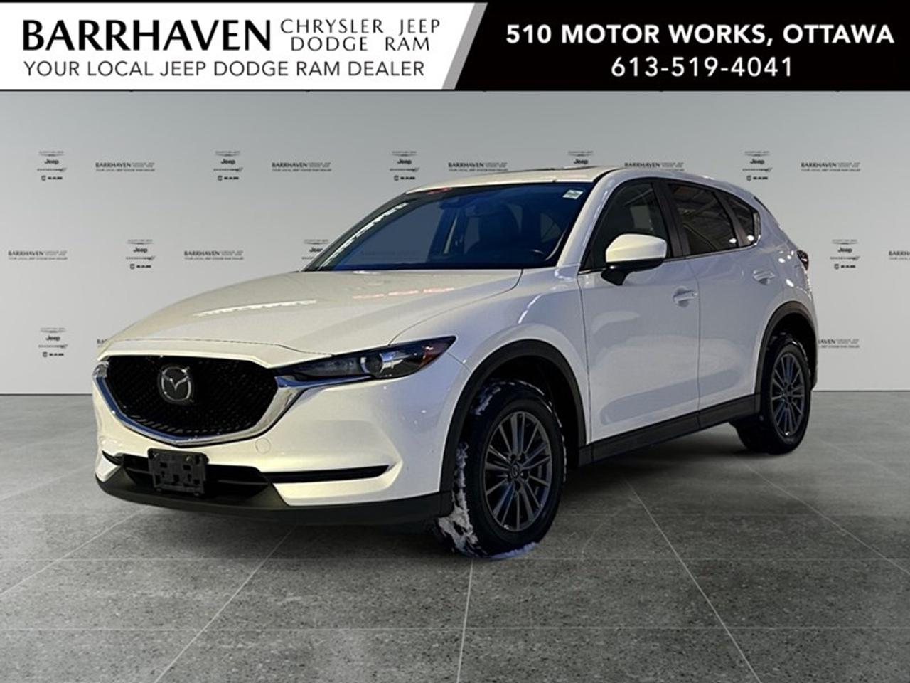 The 2017 Mazda CX-5 GS in a pristine White finish is a remarkable SUV equipped with AWD for superior handling and control on every journey. This vehicle combines elegant styling with practical design, making it an ideal choice for those who value both function and form. The CX-5 boasts a sophisticated exterior matched with sleek alloy wheels and the versatility of a sunroof, lending a stylish touch and a refreshing breeze on every drive. Inside, youll find a carefully crafted interior featuring heated seats to enhance comfort, a leather steering wheel and gear shifter that add a touch of luxury, and power seats and windows for added convenience. Stay seamlessly connected with Bluetooth integration and a smart device system, all while enjoying the peace of mind provided by a host of safety features. The inclusion of lane assist and a backup camera ensures you are in control and secure whether maneuvering through tight spots or cruising on highways. If you seek an SUV that effortlessly combines technology, comfort, and superior handling, the 2017 Mazda CX-5 GS is tailored for you. Dont hesitate to contact us today for more information or to schedule a test drive. Your future adventures await in this superb SUV.