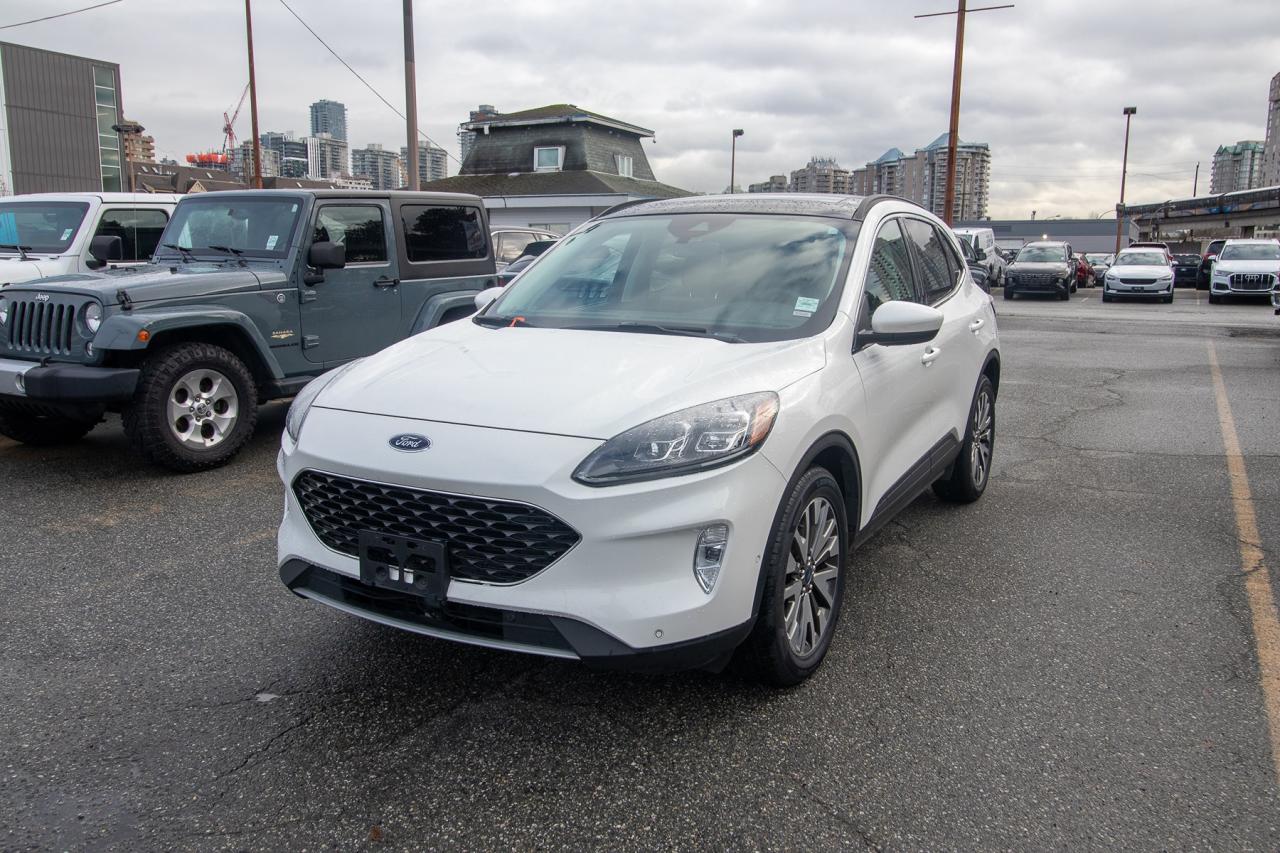 <p>Looking for a stylish and capable SUV that can handle anything the Canadian climate throws your way? Check out this stunning 2021 Ford Escape Titanium AWD, available now at Key West Ford! This sleek SUV, finished in a head-turning STAR WHIT exterior, offers a perfect blend of practicality and sophistication. Whether youre navigating city streets or embarking on a weekend adventure, the Escape Titanium AWD provides a comfortable and confident driving experience. Its automatic transmission and fuel-efficient gasoline engine make every journey a breeze.</p><p>&nbsp;</p><p>This Escape Titanium AWD is packed with features designed to enhance your driving experience. Youll appreciate the premium touches and advanced technology that make this SUV stand out from the crowd. With its spacious interior and versatile cargo area, youll have plenty of room for passengers and gear. This Escape is ready to elevate your daily commute and weekend getaways.</p><p>&nbsp;</p><p>Here are five features that will make you fall in love with this 2021 Ford Escape Titanium AWD:</p><p><br><br></p><ul><li><strong>All-Wheel Drive Confidence:</strong> Conquer any road condition with the surefootedness of all-wheel drive.</li></ul><p>&nbsp;</p><ul><li><strong>Titanium Trim Luxury:</strong> Experience premium comfort and style with the Titanium trims upscale features.</li></ul><p>&nbsp;</p><ul><li><strong>Modern Technology:</strong> Stay connected and entertained with the latest tech features.</li></ul><p>&nbsp;</p><ul><li><strong>Stylish Exterior:</strong> Turn heads with the Escapes sleek and modern design.</li></ul><p>&nbsp;</p><ul><li><strong>Spacious Interior:</strong> Enjoy a comfortable and versatile cabin for both passengers and cargo.</li></ul><p><br><br></p><p><strong><em>Powered by AutoIntelligence&trade;</em></strong><br>Vehicle information has been generated using artificial intelligence and is provided for informational purposes only. While efforts are made to ensure accuracy, please confirm all details directly with the dealer.</p><p>&nbsp;</p><p>Experience peace of mind with our Buy With Confidence program! This vehicle comes with a comprehensive mechanical and safety inspection, Carfax report, and full disclosure. We are committed to transparent pricing. The advertised price excludes fees: $699 Documentation, $349 Registration/Insurance Transfer, $695 Finance Administration Fee (if applicable), and taxes. As BCs #1 Volume Dealer and #1 for Customer Experience on DealerRater, we prioritize your satisfaction. See Key West Ford for complete details. Book your test drive today!&nbsp; Dealer #7485</p>