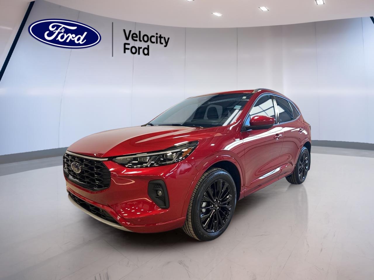 Experience the perfect blend of innovation and athletic design with the brand new 2026 Ford Escape ST-Line Elite AWD, now available at Velocity Ford in Moose Jaw. Dressed in a vibrant red exterior with a sleek black interior, this SUV is engineered for those who value style, performance, and advanced technology. With four doors and a 2.0-litre gas engine paired to an automatic transmission, it delivers a dynamic drive for city streets or open highways.

FEATURES OF THE Escape ST-Line Elite AWD  
»» Sport-inspired exterior with rear spoiler  
»» Heated front seats for Canadian winters  
»» Ambient lighting package for enhanced cabin mood  
»» Power liftgate for easy cargo access  

ADVANCED SAFETY FEATURES  
»» Blind spot monitor for safer lane changes  
»» Lane departure warning for added security  
»» Side impact and head side airbags  
»» Child safety locks for peace of mind  

PERFORMANCE AND EFFICIENCY  
»» 2.0-litre gas engine with AWD capability  
»» Limited slip differential for improved traction  
»» Performance tires for responsive handling  
»» Automatic transmission for smooth driving  

COMFORT AND CONVENIENCE  
»» Dual-zone climate control for personalized comfort  
»» Power driver and passenger seats  
»» Push button start for easy entry  
»» Heated mirrors to clear frost quickly  

TECHNOLOGY AND CONNECTIVITY  
»» Navigation system (GPS) for confident journeys  
»» Bluetooth integration for hands-free calls  
»» WiFi hotspot for on-the-go connectivity  
»» Satellite radio for endless entertainment  

CARGO SPACE  
»» Power liftgate for effortless loading  
»» Rear trunk access for large items  
»» Flexible rear seat configuration  
»» Ample space for family and gear  

WHAT OTHER OWNERS LIKE  
»» Confident all-wheel drive in all seasons  
»» Intuitive infotainment and connectivity features  
»» Spacious interior with flexible cargo options  
»» Advanced safety systems for everyday driving  

This 2026 Ford Escape ST-Line Elite AWDs VIN is: 1FMCU9PA7TUA34398.