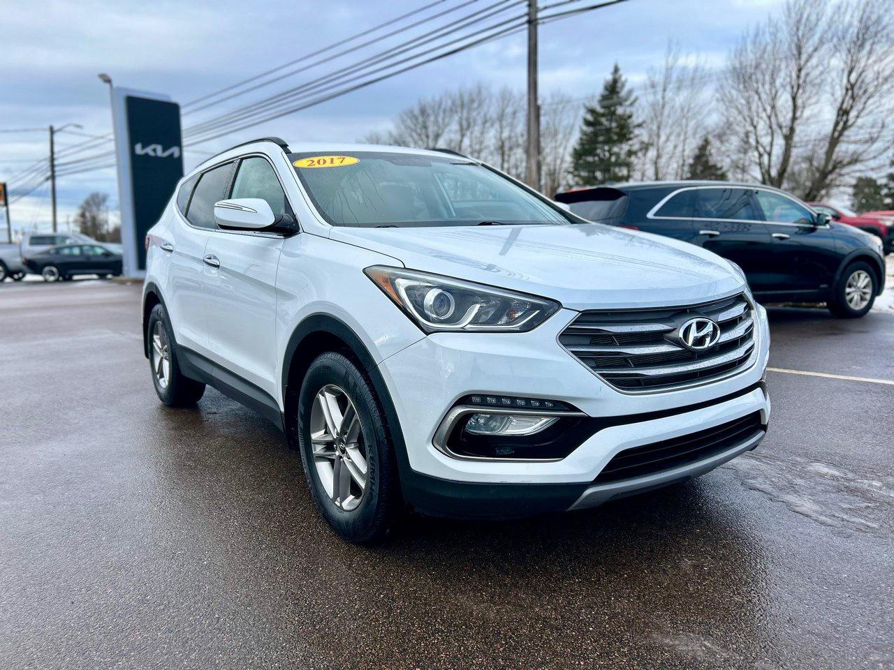 <span>This extremely low-mileage value-packed 2017 Hyundai Santa Fe Sport Premium is absolutely stuffed with features and also includes the all-weather benefits of all-wheel drive. Theres a 12-way power drivers seat, heated front and rear seats plus a heated steering wheel, dual-zone automatic climate control, blind spot monitoring, rear cross traffic alert, and rear parking assist.&nbsp;Of course, a big part of the Santa Fe Sports appeal is its spacious SUV bodystyle.<span class=Apple-converted-space>&nbsp;</span></span>




<span>The Santa Fe Sports flexibility is key, thanks to 40/20/40 split-folding rear seats, 2,025 litres of max. cargo capacity, and 39 inches of rear seat legroom. And it certainly doesnt hurt that the Santa Fe Sport is priced very affordably, as well.</span>




<p data-start=945 data-end=1053>Available now at Centennial Kia of Summerside. Call 1-902-724-4542 for details or to book your test drive.