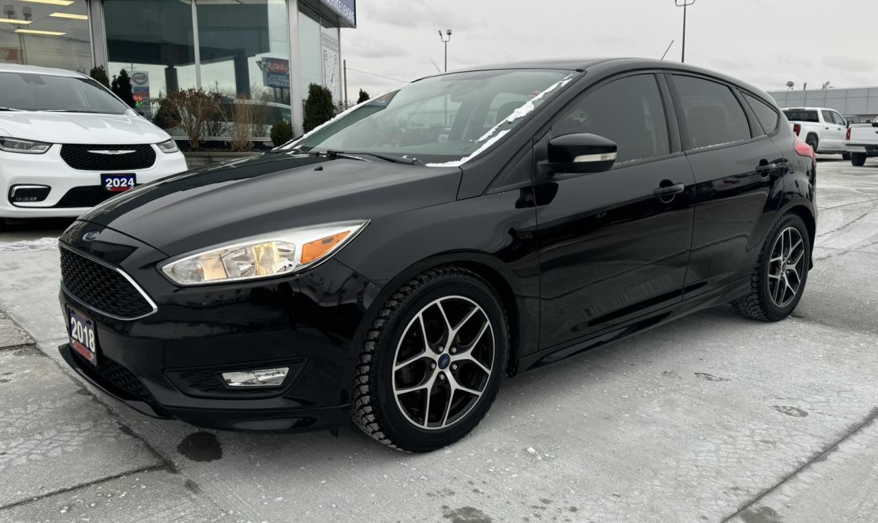 <p style=text-align: center;><span style=font-size: 18pt;><strong>2018 FORD FOCUS SE HATCH</strong></span></p><p style=text-align: center;><span style=font-size: 18pt;><strong>2.0L I4 GDI ENGINE</strong></span></p><p style=text-align: center;><span style=font-size: 14pt;>160 HORSEPOWER | 146 LB-FT TORQUE</span></p><p style=text-align: center;><span style=font-size: 14pt;>7L/100KM HIGHWAY | 9.8L/100KM CITY | 8.5L/100KM COMBINED</span></p><p style=text-align: center;><span style=font-size: 18pt;><strong>6-SPEED AUTOMATIC TRANSMISSION</strong></span></p><p style=text-align: center;><span style=font-size: 18pt;><strong>17 MACHINED ALUMINUM WHEELS</strong></span></p><p style=text-align: center;>&nbsp;</p><p style=text-align: center;><span style=font-size: 14pt;><strong>EXTERIOR</strong></span></p><p style=text-align: center;><span style=font-size: 14pt;>Daytime Running Lights, Headlamps Halogen, Mirrors Dual Power & Manual Fold-Away, Wipers Front Intermittent</span></p><p style=text-align: center;><span style=font-size: 14pt;><strong>INTERIOR</strong></span></p><p style=text-align: center;><span style=font-size: 14pt;>AM/FM MP3, Console Floor, Console Overhead, Illuminated Entry, Powerpoints Frt/Rear 12V, Steering Wheel Tilt/Telescoping, SiriusXM Satellite Radio w/6-Month Prepaid Subscription, SYNC Voice Activated System</span></p><p style=text-align: center;><span style=font-size: 14pt;><strong>FUNCTIONAL</strong></span></p><p style=text-align: center;><span style=font-size: 14pt;>ABS, AdvanceTrac Stability System, Cruise Control, Door Locks Power, Easy Fuel, Electric Power Assist Steering, MyKey, Remote Keyless Entry, Reverse Camera System, Windows Power, </span></p><p style=text-align: center;><span style=font-size: 14pt;><strong>SAFETY/SECURITY</strong></span></p><p style=text-align: center;><span style=font-size: 14pt;>Airbags Driver & Passenger, Driver Knee Airbag, LATCH Child Restraint System, Passive Anti-Theft System, Safety Belts Rear 3-Point, Side Air Bags, Side Air Curtains</span></p><p style=text-align: center;>&nbsp;</p><p style=text-align: center;><span style=font-size: 14pt;><strong>OPTIONAL EQUIPMENT</strong></span></p><p style=text-align: center;><em><span style=text-decoration: underline;><span style=font-size: 14pt;>SE Sport Package:</span></span></em><br /><span style=font-size: 14pt;>17 Machined Aluminum Wheels, Fog Lamps, Full Body Styling Kit, Select Shift Paddle Shifter</span></p><p style=text-align: center;><em><span style=text-decoration: underline;><span style=font-size: 14pt;>Winter Package:</span></span></em><br /><span style=font-size: 14pt;>Heated Seats, Heated Steering Wheel, Heated Exterior Mirrors, All-Weather Floor Mats</span></p><p style=text-align: center;><span style=font-size: 14pt;>Power Code Remote Start System</span></p><p style=text-align: center;>&nbsp;</p><p style=text-align: center;>&nbsp;</p><p style=box-sizing: border-box; margin-bottom: 1rem; margin-top: 0px; color: #212529; font-family: -apple-system, BlinkMacSystemFont, Segoe UI, Roboto, Helvetica Neue, Arial, Noto Sans, Liberation Sans, sans-serif, Apple Color Emoji, Segoe UI Emoji, Segoe UI Symbol, Noto Color Emoji; font-size: 16px; background-color: #ffffff; text-align: center; line-height: 1;><span style=box-sizing: border-box; font-family: arial, helvetica, sans-serif;><span style=box-sizing: border-box; font-weight: bolder;><span style=box-sizing: border-box; font-size: 14pt;>One Key Guaranteed with purchase. if we have a second key it will be provided, additional keys/fobs availble at a cost</span></span></span></p><p style=box-sizing: border-box; margin-bottom: 1rem; margin-top: 0px; color: #212529; font-family: -apple-system, BlinkMacSystemFont, Segoe UI, Roboto, Helvetica Neue, Arial, Noto Sans, Liberation Sans, sans-serif, Apple Color Emoji, Segoe UI Emoji, Segoe UI Symbol, Noto Color Emoji; font-size: 16px; background-color: #ffffff; text-align: center; line-height: 1;>&nbsp;</p><p style=box-sizing: border-box; margin-bottom: 1rem; margin-top: 0px; color: #212529; font-family: -apple-system, BlinkMacSystemFont, Segoe UI, Roboto, Helvetica Neue, Arial, Noto Sans, Liberation Sans, sans-serif, Apple Color Emoji, Segoe UI Emoji, Segoe UI Symbol, Noto Color Emoji; font-size: 16px; background-color: #ffffff; text-align: center; line-height: 1;><span style=box-sizing: border-box; font-family: arial, helvetica, sans-serif;><span style=box-sizing: border-box; font-weight: bolder;><span style=box-sizing: border-box; font-size: 14pt;>Here at Lanoue/Amfar Sales, Service & Leasing in Tilbury, we take pride in providing the public with a wide variety of High-Quality Pre-owned Vehicles. We recondition and certify our vehicles to a level of excellence that exceeds the Status Quo. We treat our Customers like family and provide the highest level of service from Start to Finish. If you&rsquo;d like a smooth & stress-free car shopping experience, give one of our Sales Associates a call at 1-844-682-3325 to help you find your next NEW-TO-YOU vehicle!</span></span></span></p><p>&nbsp;</p><p style=box-sizing: border-box; margin-bottom: 1rem; margin-top: 0px; color: #212529; font-family: -apple-system, BlinkMacSystemFont, Segoe UI, Roboto, Helvetica Neue, Arial, Noto Sans, Liberation Sans, sans-serif, Apple Color Emoji, Segoe UI Emoji, Segoe UI Symbol, Noto Color Emoji; font-size: 16px; background-color: #ffffff; text-align: center; line-height: 1;><span style=box-sizing: border-box; font-family: arial, helvetica, sans-serif;><span style=box-sizing: border-box; font-weight: bolder;><span style=box-sizing: border-box; font-size: 14pt;>Although we try to take great care in being accurate with the information in this listing, from time to time, errors occur. The vehicle is priced as it is physically equipped. Minor variances will not effect pricing. Please verify the vehicle is As Expected when you visit. Thank You!</span></span></span></p>