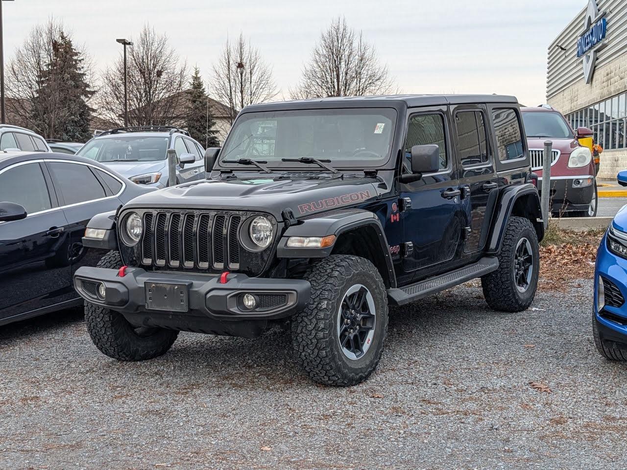 <b>Off-Road Suspension,  4G Wi-Fi,  Android Auto,  Apple CarPlay,  Navigation!</b><br> <br>    This ultra capable Jeep Wrangler was built to be tough and reliable, with next level comfort and convenience. This  2021 Jeep Wrangler is fresh on our lot in Kingston. <br> <br>No matter where your next adventure takes you, this Jeep Wrangler is ready for the challenge. With advanced traction and handling capability, sophisticated safety features and ample ground clearance, the Wrangler is designed to climb up and crawl over the toughest terrain. Inside the cabin of this Wrangler offers supportive seats and comes loaded with the technology you expect while staying loyal to the style and design youve come to know and love.This  SUV has 59,877 kms. Its  black in colour  and is completely accident free based on the <a href=https://vhr.carfax.ca/?id=Jzc2siIhHq36xIBlMlmJdEx6wDoVUsR8 target=_blank>CARFAX Report</a> . It has an automatic transmission and is powered by a  270HP 2.0L 4 Cylinder Engine.  It may have some remaining factory warranty, please check with dealer for details. <br> <br> Our Wranglers trim level is Rubicon Unlimited. This Rubicon is as tough as they come with aluminum wheels, red tow hooks, performance suspension, selectable locking differentials, more skid plates, heavy duty shocks, off road suspension, black exterior accents, remote keyless entry, voice activated air conditioning, Rubicon logo on seats, navigation, off road information pages, and wi-fi. It also comes with Uconnect4, voice activation, Android Auto, Apple CarPlay, Trail Rated badge, and a rear view camera. This vehicle has been upgraded with the following features: Off-road Suspension,  4g Wi-fi,  Android Auto,  Apple Carplay,  Navigation,  4g Wi-fi,  Fog Lamps. <br> To view the original window sticker for this vehicle view this <a href=http://www.chrysler.com/hostd/windowsticker/getWindowStickerPdf.do?vin=1C4HJXFN4MW865293 target=_blank>http://www.chrysler.com/hostd/windowsticker/getWindowStickerPdf.do?vin=1C4HJXFN4MW865293</a>. <br/><br> <br>To apply right now for financing use this link : <a href=https://www.taylorautomall.com/finance/apply-for-financing/ target=_blank>https://www.taylorautomall.com/finance/apply-for-financing/</a><br><br> <br/><br> Buy this vehicle now for the lowest bi-weekly payment of <b>$283.48</b> with $0 down for 96 months @ 8.99% APR O.A.C. ( Plus applicable taxes -  Plus applicable fees   ).  See dealer for details. <br> <br>For more information, please call any of our knowledgeable used vehicle staff at (613) 549-1311!<br><br> Come by and check out our fleet of 50+ used cars and trucks and 180+ new cars and trucks for sale in Kingston.  o~o