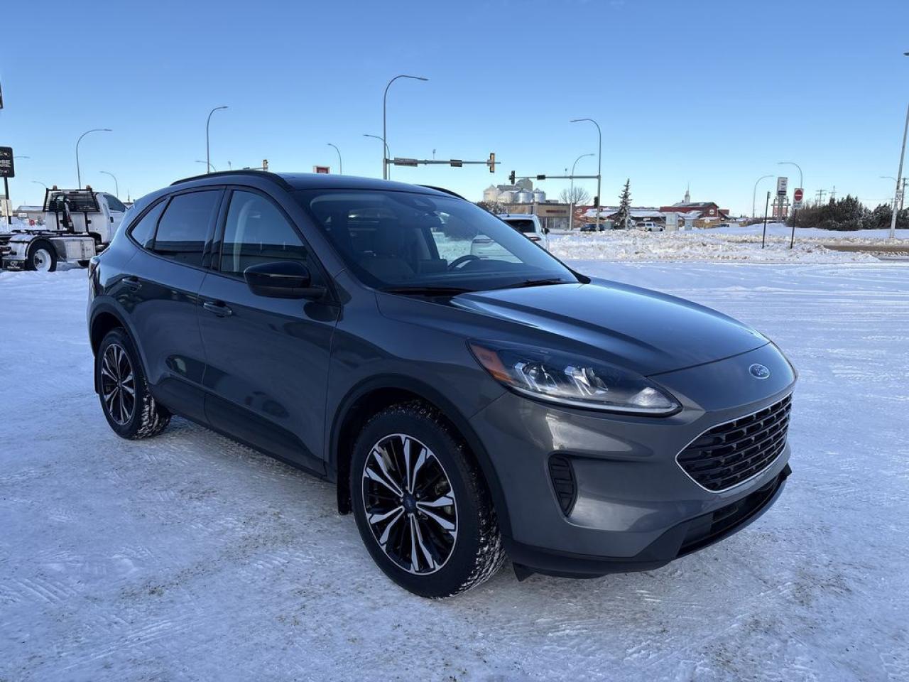 THE PRICE YOU SEE, PLUS GST. GUARANTEED!APPLE CARPLAY/ANDROID AUTO COMPATABLE! 1.5 LITER ECOBOOST, 8 SPEED AUTO, SE TRIM(200a), SE SPORT APPEARANCE PKG, COLD WEATHER PKG, HEATED STEERING WHEEL, HEATED FRONT SEATS, REMOTE START SYSTEM, PANORAMIC VISTA ROOF, ADAPTIVE CRUISE, SYNC 3 INFOTAINMENT SCREEN 13.2, NAV.      The 2022 Ford Escape SE AWD equipped with the 200A package and the 1.5-liter EcoBoost engine presents a well-rounded compact SUV that combines performance, comfort, and versatility. The 1.5-liter EcoBoost turbocharged three-cylinder engine delivers approximately 181 horsepower and 190 lb-ft of torque, offering a good balance of responsive acceleration and fuel efficiency, especially paired with the all-wheel-drive system for enhanced traction and stability in various driving conditions. The SE trim adds a sporty yet refined interior with features such as cloth or optional leather upholstery, a user-friendly infotainment system with a touchscreen display, Apple CarPlay, Android Auto, and additional comfort amenities. The 200A package enhances the vehicle with desirable technology and convenience features, including upgraded driver-assist systems like blind-spot monitoring, rear cross-traffic alert, and a more sophisticated infotainment setup. A standout feature of this configuration is the panoramic vista roof, which provides an expansive glass roof that floods the cabin with natural light and offers an open, airy feeling for all passengers. Overall, the 2022 Ford Escape SE AWD with the 200A package and panoramic vista roof is an appealing choice for those seeking a stylish, capable, and tech-savvy compact SUV with a focus on comfort and versatility.Do you want to know more about this vehicle, CALL, CLICK OR COME ON IN!*AMVIC Licensed Dealer; CarFax and Full Mechanical Inspection Included.