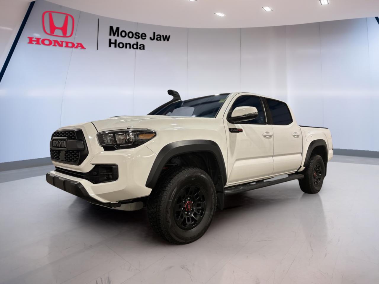 Experience legendary reliability and rugged capability with the 2019 Toyota Tacoma TRD PRO, now available at Moose Jaw Honda. Finished in classic white and featuring an automatic transmission, this used Tacoma has only 43,753 km on the odometer. Built for adventure and everyday practicality, its ready for work or play around Moose Jaw.

TRUCK FEATURES
»» Impressive towing capacity for versatile hauling needs
»» Durable bed design for tough cargo jobs
»» High ground clearance for challenging terrain
»» Robust frame engineered for long-term durability

ADVANCED SAFETY FEATURES
»» Backup camera for confident reversing and parking
»» Advanced airbag system for occupant protection
»» Stability control for secure handling on any road
»» Anti-lock braking system enhances stopping power

PERFORMANCE AND EFFICIENCY
»» Reliable V6 engine delivers strong performance
»» Smooth-shifting automatic transmission
»» Four-wheel drive for enhanced off-road capability
»» Efficient fuel consumption for a midsize truck

COMFORT AND CONVENIENCE
»» Spacious double cab with ample legroom
»» Automatic climate control for year-round comfort
»» Power windows and door locks for easy access
»» Tilt and telescopic steering wheel adjustment

TECHNOLOGY AND CONNECTIVITY
»» Touchscreen display for intuitive control
»» Bluetooth connectivity for hands-free calls
»» USB port for device charging and music
»» Integrated audio system for quality sound

CARGO SPACE
»» Versatile truck bed for gear and equipment
»» Easy-lower tailgate for convenient loading
»» Multiple tie-down points secure your cargo
»» Rear seats fold for additional storage options

WHAT OTHER OWNERS LIKE
»» Dependable performance in all weather conditions
»» Comfortable ride for daily driving or road trips
»» User-friendly technology features and controls
»» Strong resale value and long-term reliability

This 2019 Toyota Tacomas VIN is: 5TFCZ5AN3KX190462.