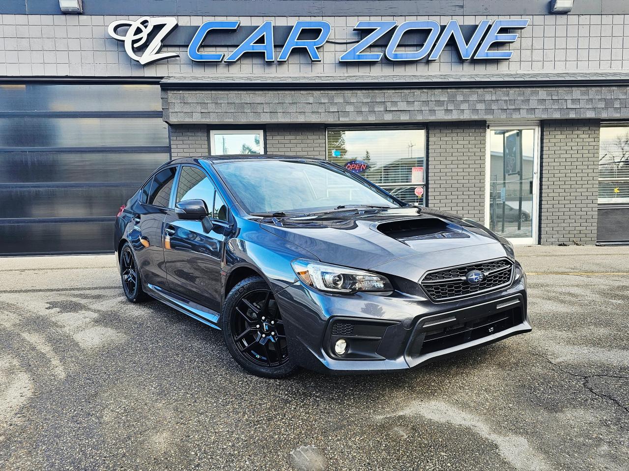 <p>Looking for a sporty and reliable sedan that can handle any Canadian weather? Check out this pre-owned 2018 Subaru WRX Sport-tech CVT, available now at Car Zone! This sleek grey sedan boasts a powerful 2.0L I4 Turbo engine, ready to deliver an exhilarating driving experience. With its iconic all-wheel drive system, youll feel confident and in control, whether youre navigating city streets or cruising along the highway. Inside, youll find a comfortable black interior, perfect for those long drives. This WRX has a recorded 157,193km on the odometer.</p><p>This WRX Sport-tech CVT is packed with features designed to enhance your driving experience. Heres a taste of what awaits you:</p><ul><li><strong>Turbocharged Thrills:</strong> Experience the raw power and responsive performance of the turbocharged engine.</li><li><strong>All-Wheel Drive Confidence:</strong> Conquer any road condition with Subarus legendary all-wheel-drive system.</li><li><strong>Sport-tech Luxury:</strong> Enjoy premium features and a comfortable cabin.</li><li><strong>Seamless CVT Transmission:</strong> Experience smooth and efficient gear changes for an effortless drive.</li><li><strong>Iconic Styling:</strong> Turn heads with the WRXs aggressive and sporty design.</li></ul><p>Visit Car Zone today and take this impressive 2018 Subaru WRX Sport-tech CVT for a test drive!</p><p>&nbsp;</p><p>Looking for Your Dream Car? Call Car Zone Today!</p><p>&nbsp;</p><p>All of our vehicles come fully detailed with a Carfax and a mechanical fitness assessment. Drive this home today! Easy financing options. All credit welcome.&nbsp;<a href=http://www.carzonecalgary.com/financing/>APPLY NOW</a>&nbsp;We even take trades. Same day approvals at&nbsp;<a href=http://www.carzonecalgary.com/>CARZONECALGARY</a> or visit us in person at 2036 36 Street SE Calgary for a hassle free test drive. Let our friendly team of experts book an appointment with you and show you the Car Zone difference! AMVIC licensed dealer.&nbsp;</p>