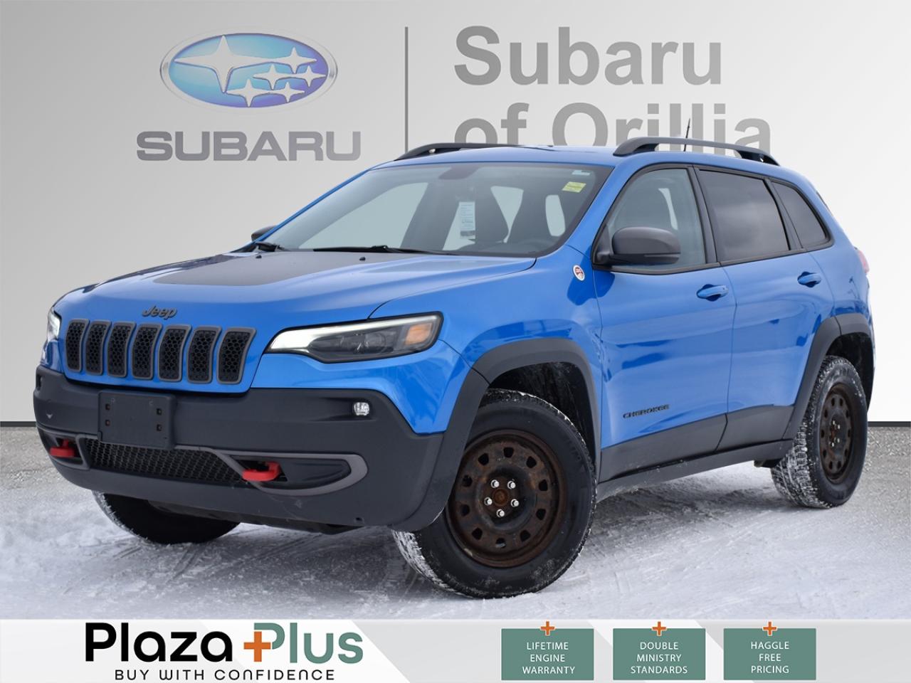 This 2019 Jeep Cherokee Trailhawk 4x4 finished in striking Hydro Blue Pearl with a Black interior is a true Canadian-spec SUV built for all-weather confidence, rugged capability, and budget-friendly ownership. With 96,179 kms and two sets of tires on rims, this Trailhawk offers exceptional value for drivers who want year-round performance without sacrificing comfort or technology.    Under the hood is Jeeps proven 3.2L Pentastar VVT V6 engine paired with a 9-speed automatic transmission, delivering smooth power and long-term reliability. The Trailhawks advanced Jeep Active Drive II 4x4 system with Selec-Terrain® Traction Management is designed for Canadian conditions, offering dedicated modes for Snow, Mud, Sand, and Rock. Combined with Hill Start Assist, Hill Descent Control, and Selec-Speed Control, this Cherokee is equally capable in winter storms, on cottage roads, or off the beaten path.    The interior blends durability with comfort. Leather-faced bucket seats with cloth inserts, a power 8-way adjustable drivers seat with lumbar support, heated front seats, and a heated steering wheel make it ideal for cold Canadian winters. Added convenience features include remote start, dual-zone automatic climate control, push-button start, a power liftgate, and all-weather floor mats, enhancing everyday usability.    Technology is highlighted by the Uconnect® 4C NAV system with an 8.4-inch touchscreen, offering built-in GPS navigation, Apple CarPlay® and Android Auto™, SiriusXM , Bluetooth connectivity, USB inputs, and an available 4G LTE Wi-Fi hotspot. The 7-inch customizable digital instrument cluster and ambient LED interior lighting add a modern, premium feel.    Safety is well covered with advanced features such as blind-spot monitoring with rear cross-path detection, Park-Sense rear park assist, a rear back-up camera, electronic stability control, multiple airbag systems, and LATCH child seat anchors, providing peace of mind for families and daily driving.    On the exterior, the Trailhawk stands out with LED headlights, fog lights, daytime running lights, and taillamps, along with 18-inch wheels, heated power mirrors, and serious off-road protection including fuel tank, transmission, suspension, and underbody skid plates—a hallmark of the Trailhawk name.    Overall, this 2019 Jeep Cherokee Trailhawk 4x4 is a reliable, budget-friendly, and highly capable SUV, perfectly suited for Canadian weather and lifestyles. With its strong V6 performance, true 4x4 capability, premium features, and two sets of tires on rims, it delivers outstanding value and confidence in every season.    At Subaru of Orillia, our pre-owned vehicle pricing policy is simple. We use no hassle, no haggle, live market pricing! Save time and money. Do business the way you want with all the details completely online! This includes trade appraisal and financing with touchless delivery to your home or office. Now thats attention to the details. Come see us at any time if you want exceptional service, or as we call it, Plaza service.    All prices shown include all fees, reconditioning costs, Car Fax report and complete vehicle detailing. Taxes and licensing extra.