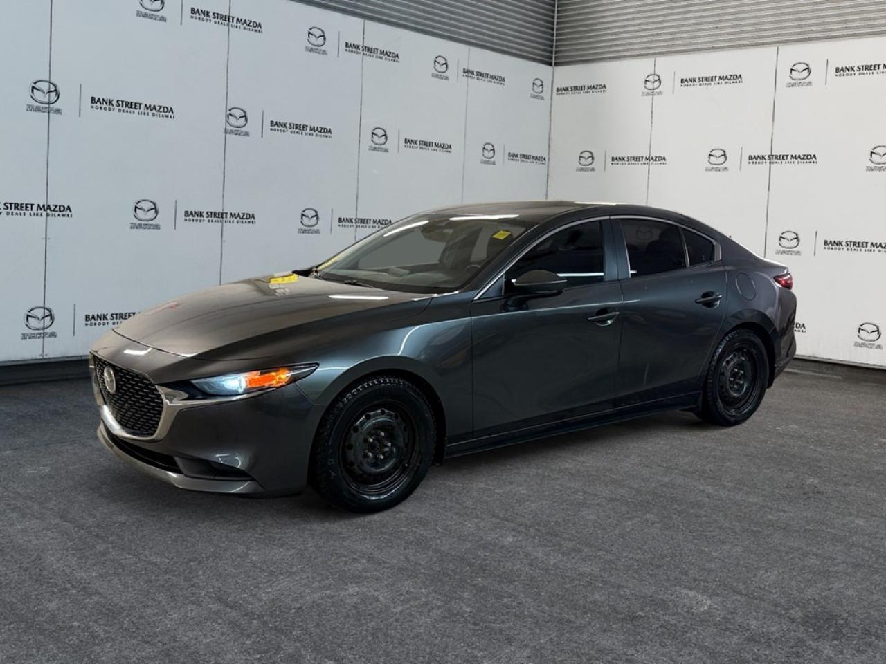 Step into the world of elegance and performance with this 2019 Mazda Mazda3 GS Auto FWD in a sleek sedan style. With a refined Automatic transmission and the efficiency of a Front-Wheel Drive system, this vehicle ensures a seamless driving experience thats both secure and responsive. The exterior of this Mazda3 captivates with its striking alloy wheels and dynamic design, making every drive a pleasure. Inside, comfort meets sophistication with a spacious cabin featuring Heated Front Seats and a Leather Steering Wheel that enhances every touch. Seamlessly integrate your smart device with connectivity options, while the enduring practicality of Power Windows and Keyless Entry enhance everyday convenience. Technology and safety are at the forefront of this model, boasting a Backup Camera for easy parking and Lane Assist to keep you confidently rooted on the road. Engage Adaptive Cruise Control for a stress-free highway journey, while Heated Mirrors ensure clarity in all conditions. This 2019 Mazda3 GS Auto FWD is tailor-made for professionals seeking a reliable and stylish companion for their daily commutes, as well as families desiring a safe, connected ride. Contact our dealership today to learn more and arrange your test drive.