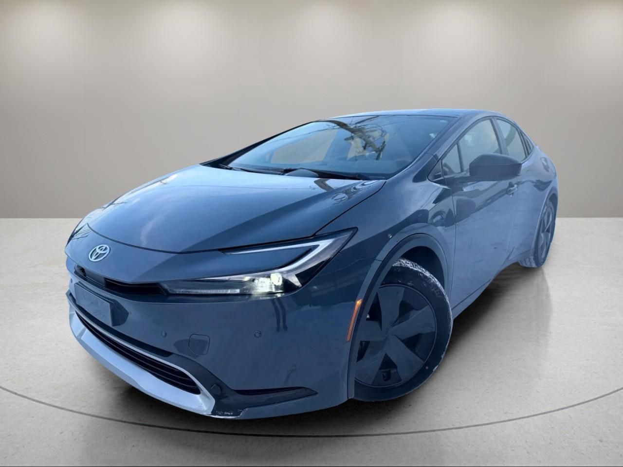 <p>The 2023 Toyota Prius Prime in a refined gray finish offers the smooth handling of a Front-Wheel Drive system, ensuring a responsive and efficient driving experience. This sedan is styled to impress, with sophisticated alloy wheels that complement its contemporary design.</p><p>Inside, the gray interior welcomes you with comfort and advanced features. Heated seats provide warmth on those chilly Canadian mornings, while the smart device integration ensures your favorite apps and navigation tools are always within reach. The Prius Prime is equipped with a user-friendly backup camera that enhances your parking ease, and keyless entry adds to the convenience of your daily drives.</p><p>Safety and technology go hand in hand with features such as lane assist, which helps keep you on track, and brake assist for added stopping power. Stay connected on the go with Bluetooth connectivity and enjoy a variety of channels via satellite radio.</p><p>Whether you're a tech enthusiast, a commuter looking for reliability, or someone who values eco-friendly options, the 2023 Toyota Prius Prime is tailored for you. Reach out to our dealership today to learn more and schedule your test drive.</p>