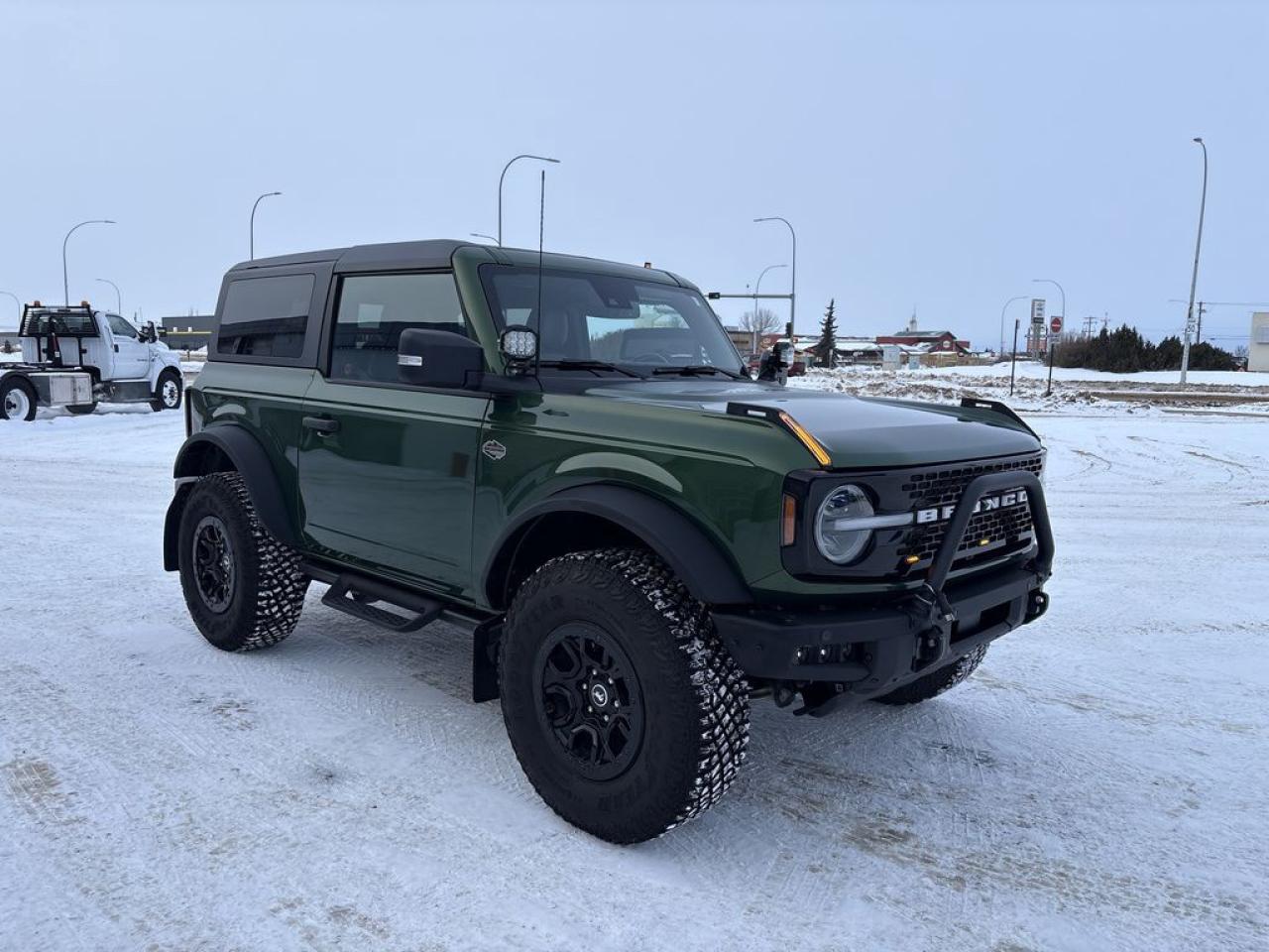 THE PRICE YOU SEE, PLUS GST. GUARANTEED!APPLE CARPLAY/ANDROID AUTO COMPATABLE!***AFTERMARKET LIGHTS***2.7 LITER ECOBOOST, 10 SPEED AUTO, 2 DOOR WILDTRACK(354a), LEATHER TRIMMED/VINYL SEATS, ADAPTIVE CRUISE, HARD TOP-MIC, ENGINE BLOCK HEATER, BRUSH GUARD, SOUND DEADENING HEAD LINER, 360 DEGREE CAMERAS, HEATED STEERING WHEEL, SASQUATCH PKG.     The 2024 Ford Bronco Wildtrak 2-door with the Sasquatch package is a highly capable and rugged off-road vehicle designed for adventure enthusiasts. It features a distinctive, sporty exterior with aggressive styling cues, including wider fender flares and off-road-specific accents. Under the hood, it is powered by a 2.7-liter twin-turbo V6 engine that delivers robust performance, offering a blend of power and efficiency suitable for both on-road driving and challenging off-road terrains. The 354A package enhances the vehicles technology and convenience, including features such as upgraded infotainment, premium audio, and advanced driver-assistance systems, making it both a capable off-roader and a comfortable daily driver. The Sasquatch package further elevates its off-road prowess by adding 35-inch tires, high-clearance fender flares, locking front and rear axles, and Bilstein shock absorbers, which significantly improve ground clearance, traction, and stability on rough trails. Overall, the 2024 Bronco Wildtrak with these packages combines rugged durability, advanced off-road features, and modern technology to deliver a versatile and exciting vehicle for outdoor adventurers.Do you want to know more about this vehicle, CALL, CLICK OR COME ON IN!*AMVIC Licensed Dealer; CarFax and Full Mechanical Inspection Included.