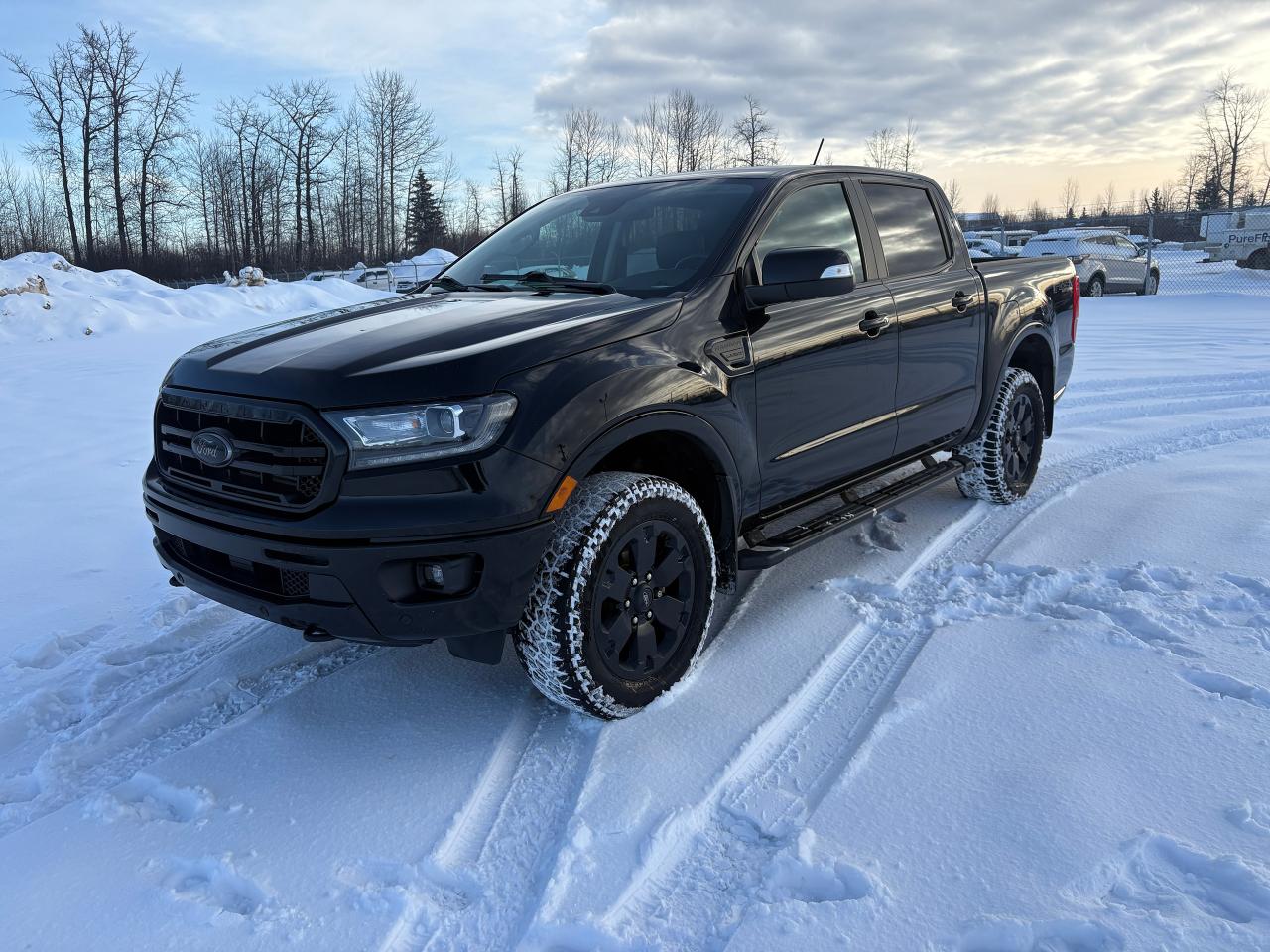 <p data-start=130 data-end=172><strong data-start=130 data-end=172>2021 Ford Ranger Lariat &ndash; Shadow Black</strong></p><p data-start=174 data-end=724>Bold, refined, and built to perform, the 2021 Ford Ranger Lariat in Shadow Black delivers midsize truck capability with premium style. Its aggressive stance is highlighted by a chrome grille, black exterior accents, LED lighting with automatic high beams, fog lamps, and 18-inch machined aluminum wheels with stealth grey pockets. The Black Appearance Package, black running boards, spray-in ToughBed&reg; bedliner, cargo lighting, and trailer tow equipment give this Ranger a rugged, ready-for-anything look that stands out on the road and on the trail.</p><p data-start=726 data-end=1314>Inside, the Ranger Lariat offers upscale comfort and smart design. Heated leather-trimmed bucket seats, a leather-wrapped steering wheel, piano black interior accents, and dual-zone automatic climate control create a refined cabin experience. The technology package adds SYNC&reg; 3 with navigation, a premium B&O&reg; 10-speaker sound system, SiriusXM&reg;, HD Radio&trade;, and a crisp touchscreen interface. Thoughtful storage throughout, a full centre console, auto-dimming rearview mirror, and garage door opener make this truck as comfortable for daily driving as it is capable for work or adventure.</p><p data-start=1316 data-end=1817>Power comes from the proven <strong data-start=1344 data-end=1369>2.3L EcoBoost&reg; engine</strong>, paired with an electronic 10-speed SelectShift&reg; automatic transmission for smooth acceleration and impressive efficiency. With <strong data-start=1498 data-end=1523>FX4&reg; Off-Road Package</strong>, off-road-tuned suspension, skid plates, Trail Control&trade;, electronic-locking rear differential, and part-time four-wheel drive, this Ranger is engineered to tackle rough terrain with confidence. A 7,500-lb towing capacity and trailer sway control make it equally capable when it&rsquo;s time to haul.</p><p data-start=1819 data-end=2185>Safety and driver-assist features are extensive, thanks to <strong data-start=1878 data-end=1899>Ford Co-Pilot360&trade;</strong>, including Blind Spot Information System with trailer tow coverage, Cross-Traffic Alert, Automatic Emergency Braking, forward collision warning, adaptive cruise control, and a rear-view camera. FordPass&trade; Connect with a 4G mobile hotspot keeps you connected wherever the road takes you.</p><p data-start=2187 data-end=2379>Stylish, powerful, and packed with premium features, the 2021 Ford Ranger Lariat is the perfect blend of luxury and off-road capability&mdash;ready for the job site, the highway, or the trail ahead.</p><hr data-start=2381 data-end=2384>