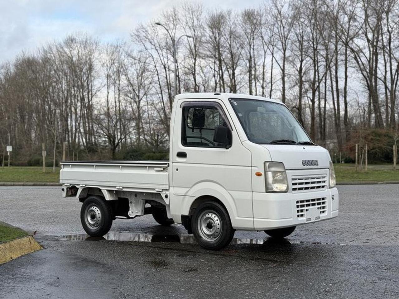 The 2009 Suzuki Carry DA65T JDM kei truck is a compact and efficient Japanese import powered by a 660cc 3-cylinder engine paired with a manual transmission and rear-wheel drive. Known for its reliability and ultra-low operating costs, this kei truck is well suited for light-duty work, property maintenance, deliveries, farm use, or recreational applications. Equipped with AM/FM radio, a simple and functional two-door cab, and a cloth interior, it offers straightforward operation with a small footprint that excels in tight spaces. Finished in white with a grey interior, this low-kilometre JDM kei truck is an increasingly popular option for buyers seeking an economical, maneuverable, and unique utility vehicle.  $11,850.00 plus $375 processing fee, $12,225.00 total payment obligation before taxes.   Listing report, warranty, contract commitment cancellation fee, financing available on approved credit (some limitations and exceptions may apply). All above specifications and information is considered to be accurate but is not guaranteed and no opinion or advice is given as to whether this item should be purchased. We do not allow test drives due to theft, fraud, acts of vandalism and undetectable impaired driving. Instead we provide the following benefits: Complimentary Warranty (with options to extend), Limited Money Back Satisfaction Guarantee on Fully Completed Contracts, Contract Commitment Cancellation, and an Open-Ended Sell-Back Option. Ask seller for details or call 604-522-REPO(7376) to confirm listing availability.