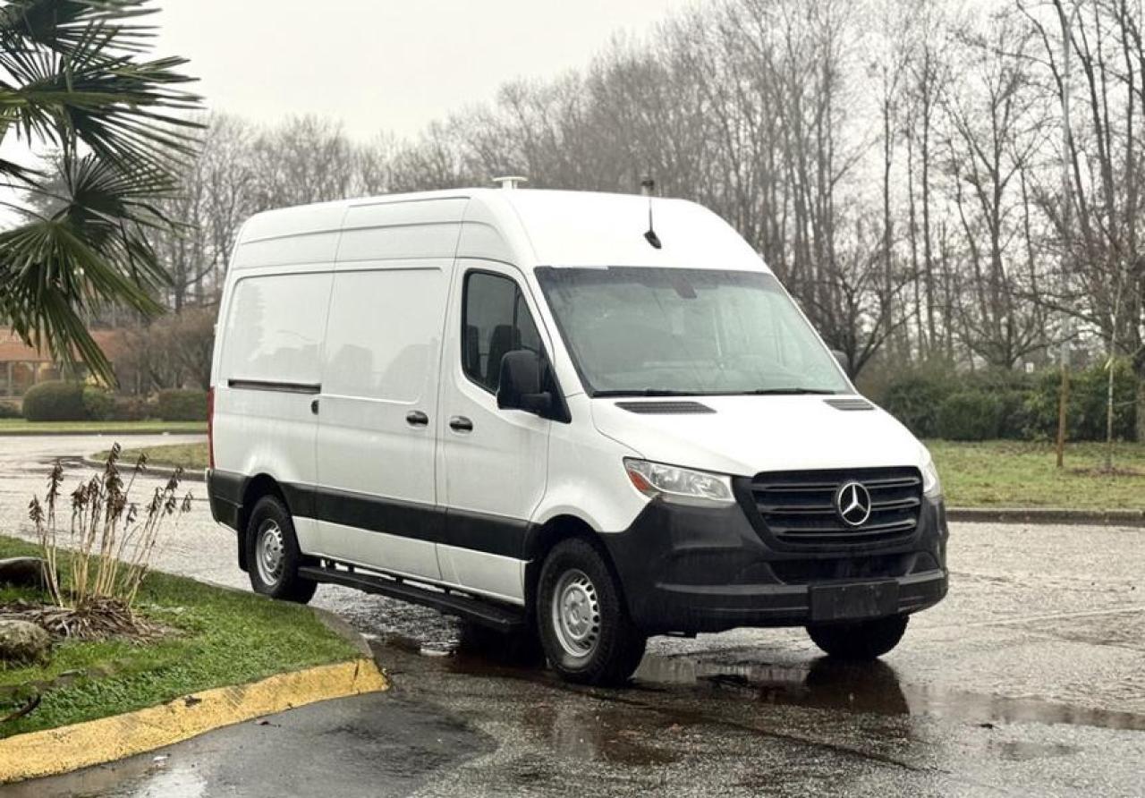 This 2019 Mercedes-Benz Sprinter 2500 High Roof Cargo Van is powered by a 3.0L V6 engine paired with an automatic transmission and 4x2 drivetrain. The high roof configuration provides increased interior standing room, making it well-suited for commercial, service, and delivery applications. Outfitted with rear work shelving and a cargo lock, the cargo area is organized for tools, equipment, or inventory storage. Cab features include air conditioning and heat, AM/FM radio, cruise control, engine push start, power windows, power door locks, power mirrors, and cup holders. Finished in white with a black cloth interior, this Sprinter cargo van is configured for practical day-to-day business use where interior space and accessibility are key.  $35,590.00 plus $375 processing fee, $35,965.00 total payment obligation before taxes.  Listing report, warranty, contract commitment cancellation fee, financing available on approved credit (some limitations and exceptions may apply). All above specifications and information is considered to be accurate but is not guaranteed and no opinion or advice is given as to whether this item should be purchased. We do not allow test drives due to theft, fraud, acts of vandalism and undetectable impaired driving. Instead we provide the following benefits: Complimentary Warranty (with options to extend), Limited Money Back Satisfaction Guarantee on Fully Completed Contracts, Contract Commitment Cancellation, and an Open-Ended Sell-Back Option. Ask seller for details or call 604-522-REPO(7376) to confirm listing availability.