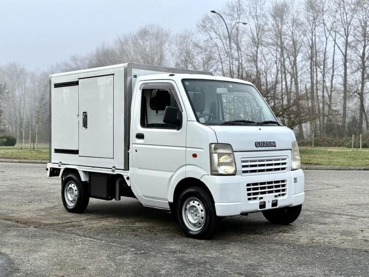 This 2009 Suzuki Carry 4x4 ThermoKing reefer kei truck is a compact refrigerated commercial vehicle powered by a 660cc 3-cylinder engine paired with a 5-speed manual transmission and selectable 4WD with Hi/Lo. It is equipped with a ThermoKing refrigeration unit (Model #505611-2131) capable of maintaining temperatures down to approximately -1, along with an insulated cargo box fitted with food trays and a rear sink for cold-storage handling. Additional features include air conditioning and heat, AM/FM radio, ThermoKing control panel, and a 2-door cab with cloth seating. Finished in white with a grey interior, this kei truck offers a compact refrigerated transport solution for tight access areas and light-duty delivery use. This item is currently OFFSITE. You must register an appointment with our office to schedule an offsite viewing. Appointments must be made a minimum of one business day in advance (and as defined by the days that Repo.com is open for business) before your appointment can be scheduled and confirmed. We may, at our own discretion, instead opt to transport smaller items to Repo.coms main yard for viewing purposes.  $14,810.00 plus $375 processing fee, $15,185.00 total payment obligation before taxes.  Listing report, warranty, contract commitment cancellation fee, financing available on approved credit (some limitations and exceptions may apply). All above specifications and information is considered to be accurate but is not guaranteed and no opinion or advice is given as to whether this item should be purchased. We do not allow test drives due to theft, fraud, acts of vandalism and undetectable impaired driving. Instead we provide the following benefits: Complimentary Warranty (with options to extend), Limited Money Back Satisfaction Guarantee on Fully Completed Contracts, Contract Commitment Cancellation, and an Open-Ended Sell-Back Option. Ask seller for details or call 604-522-REPO(7376) to confirm listing availability.