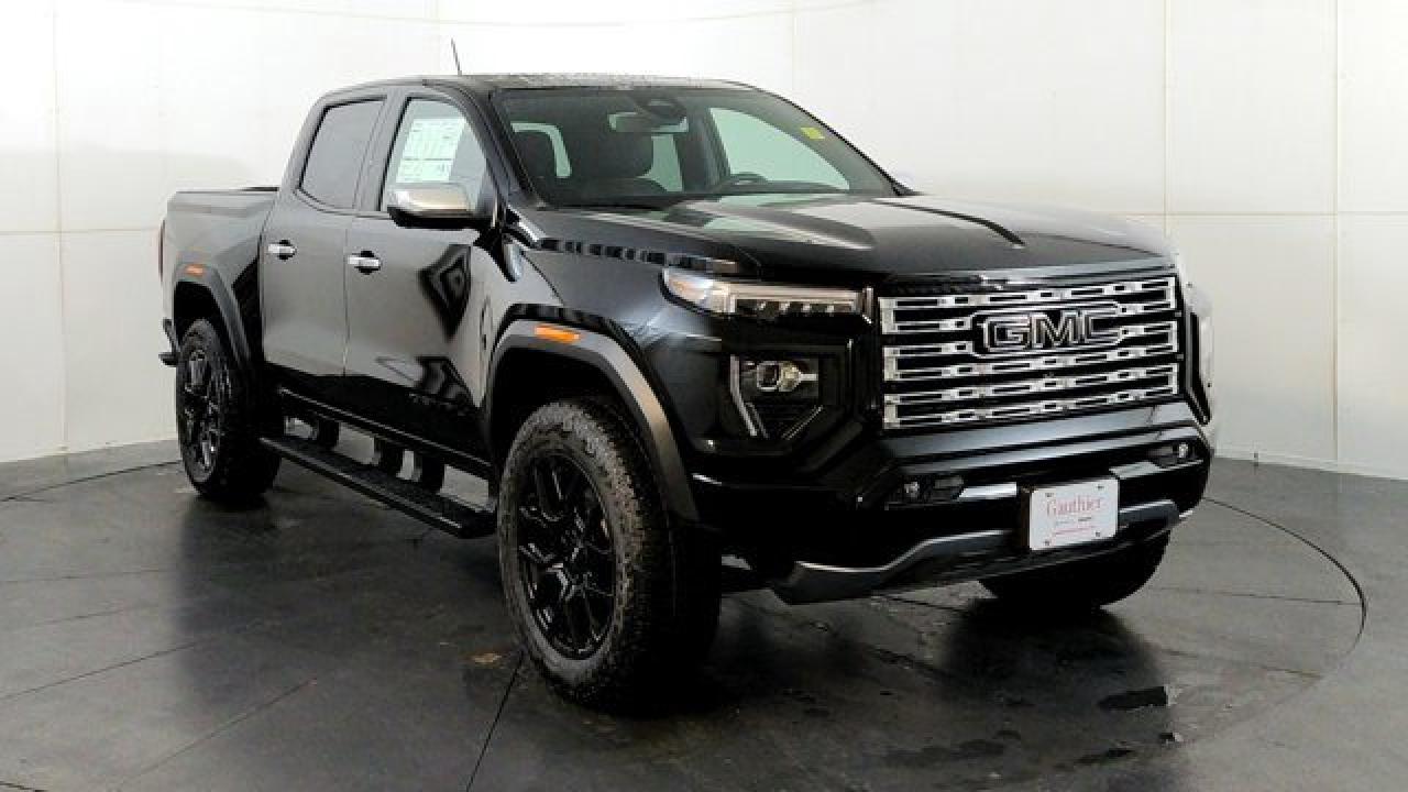 The 2026 GMC Canyon Denali blends upscale comfort with rugged capability, featuring a high-torque 310-hp TurboMax engine alongside a 2-inch factory lift and ultra-wide stance for confident off-road and trailering performance---boasting a towing capacity of up to 7,700 lbs. Its refined interior showcases Denali-exclusive Jet-Black leather-appointed seats with teak wood accents, a first-in-class 6.3-inch multicolor head-up display, a sunroof and a Bose premium audio system complemented by an 11.3-inch center touchscreen and HD Surround Vision with up to 10-camera views including unique underbody perspectives. Outside, the truck distinguishes itself with a sculpted chrome grille, exclusive 20-inch diamond-cut aluminum wheels, chrome assist steps, and a MultiStow tailgate offering integrated storage with a drain, perfectly balancing style and utility.