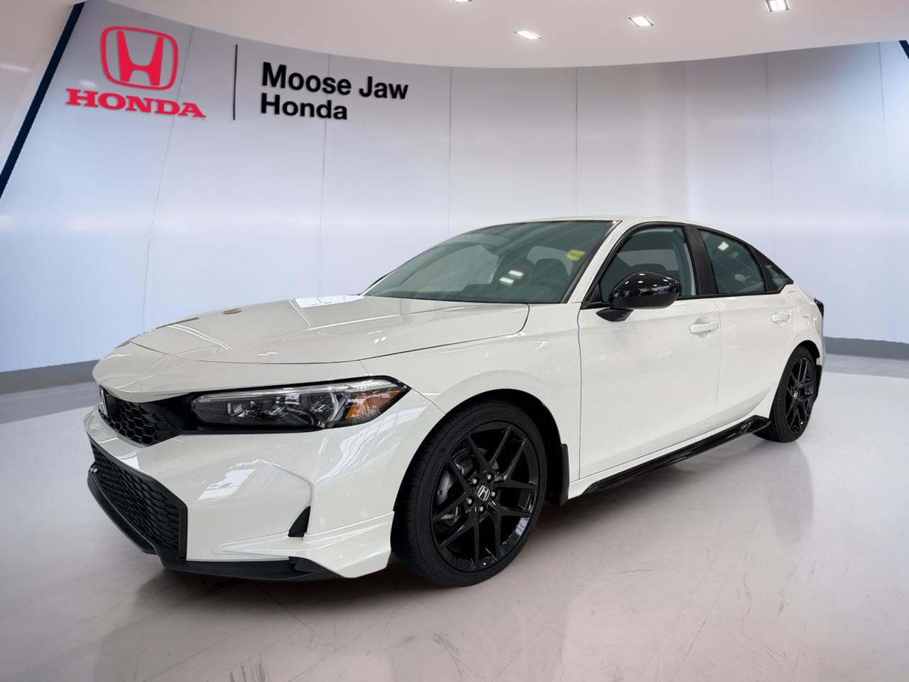 Experience the thrill of driving a brand new 2026 Honda Civic Sedan Sport, now available at Moose Jaw Honda in Moose Jaw. With its elegant white exterior and sleek black interior, this sedan blends modern design with advanced engineering. The efficient 2.0L 16-Valve DOHC Dual-VTC In-Line 4-cylinder engine and smooth Continuously Variable Transmission (CVT) deliver a dynamic and responsive ride. Front-wheel drive ensures confident handling, making every journey enjoyable and secure.

FEATURES OF THE Civic Sedan Sport  
»» 2.0L 16-Valve DOHC Dual-VTC engine  
»» Continuously Variable Transmission (CVT)  
»» Front-wheel drive for reliable traction  
»» White exterior with black interior  

ADVANCED SAFETY FEATURES  
»» Comprehensive airbag system for all passengers  
»» Anti-lock braking system for enhanced control  
»» Electronic stability control for safer driving  
»» Tire pressure monitoring system  

PERFORMANCE AND EFFICIENCY  
»» 2.0L In-Line 4-cylinder engine  
»» Responsive acceleration with CVT  
»» Excellent fuel efficiency for daily commutes  
»» Smooth, quiet ride at all speeds  

COMFORT AND CONVENIENCE  
»» Spacious seating for five passengers  
»» Automatic climate control for year-round comfort  
»» Ample legroom in both front and rear  
»» Easy-to-use controls within reach  

TECHNONOLGY AND CONNECTIVITY  
»» Modern infotainment system with touchscreen display  
»» Bluetooth connectivity for hands-free calls  
»» USB ports for device charging  
»» Steering wheel-mounted audio controls  

CARGO SPACE  
»» Generous trunk capacity for luggage  
»» Split-folding rear seats for added flexibility  
»» Wide trunk opening for easy loading  
»» Convenient storage compartments throughout cabin  

WHAT OTHER OWNERS LIKE  
»» Reliable and efficient engine performance  
»» Comfortable ride quality for long trips  
»» User-friendly technology features  
»» Attractive and modern exterior design  

This 2026 Honda Civic Sedan Sports VIN is: 2HGFE2F51TH105979.<p> now available at Moose Jaw Honda in Moose Jaw. With its elegant white exterior and sleek black interior</p>
<p> this sedan blends modern design with advanced engineering. The efficient 2.0L 16-Valve DOHC Dual-VTC In-Line 4-cylinder engine and smooth Continuously Variable Transmission (CVT) deliver a dynamic and responsive ride. Front-wheel drive ensures confident handling</p>
<p> making every journey enjoyable and secure.

FEATURES OF THE Civic Sedan Sport  
»» 2.0L 16-Valve DOHC Dual-VTC engine  
»» Continuously Variable Transmission (CVT)  
»» Front-wheel drive for reliable traction  
»» White exterior with black interior  

ADVANCED SAFETY FEATURES  
»» Comprehensive airbag system for all passengers  
»» Anti-lock braking system for enhanced control  
»» Electronic stability control for safer driving  
»» Tire pressure monitoring system  

PERFORMANCE AND EFFICIENCY  
»» 2.0L In-Line 4-cylinder engine  
»» Responsive acceleration with CVT  
»» Excellent fuel efficiency for daily commutes  
»» Smooth</p>
<p> quiet ride at all speeds  

COMFORT AND CONVENIENCE  
»» Spacious seating for five passengers  
»» Automatic climate control for year-round comfort  
»» Ample legroom in both front and rear  
»» Easy-to-use controls within reach  

TECHNONOLGY AND CONNECTIVITY  
»» Modern infotainment system with touchscreen display  
»» Bluetooth connectivity for hands-free calls  
»» USB ports for device charging  
»» Steering wheel-mounted audio controls  

CARGO SPACE  
»» Generous trunk capacity for luggage  
»» Split-folding rear seats for added flexibility  
»» Wide trunk opening for easy loading  
»» Convenient storage compartments throughout cabin  

WHAT OTHER OWNERS LIKE  
»» Reliable and efficient engine performance  
»» Comfortable ride quality for long trips  
»» User-friendly technology features  
»» Attractive and modern exterior design  

This 2026 Honda Civic Sedan Sports VIN is: 2HGFE2F51TH105979.</p>