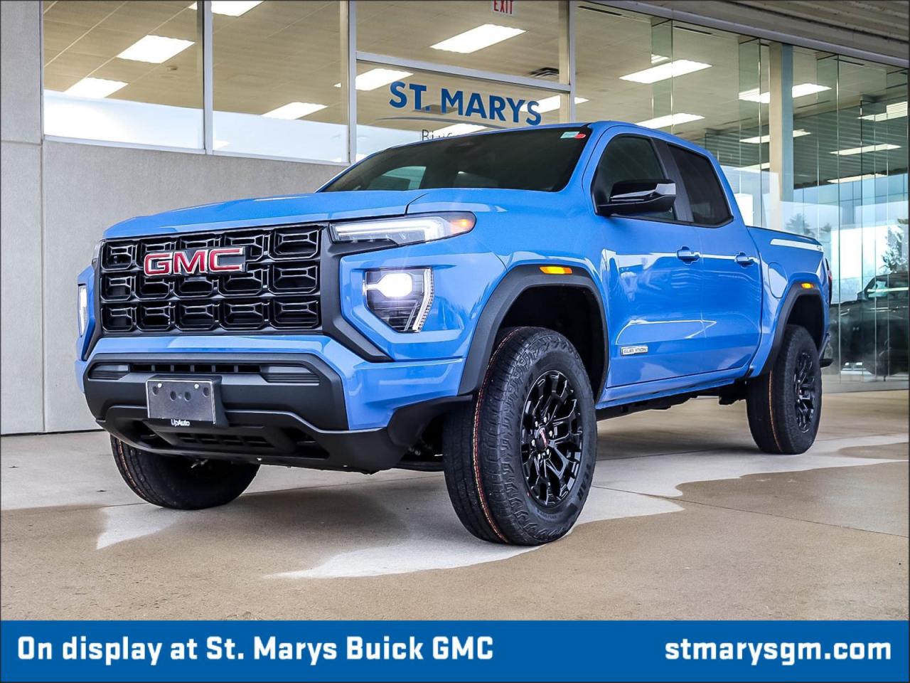 <h1>2026 GMC Canyon Elevation</h1><p>The 2026 GMC Canyon Elevation is designed for those who crave adventure while enjoying modern luxury. With its powerful Turbomax engine and bold exterior, this vehicle is perfect for both city driving and off-road escapades.</p><h2>Key Features:</h2><ul><li><strong>Turbomax Engine:</strong> Delivering impressive performance and efficiency, this engine ensures a powerful driving experience whether on highways or rugged terrains.</li><li><strong>Rapids Metallic Exterior Colour:</strong> The shimmering finish adds an eye-catching flair, making this vehicle stand out in any setting.</li><li><strong>Pro Grade Trailering System:</strong> Experience seamless towing capabilities with advanced features designed to make hauling easier and safer.</li><li><strong>Multifunction Tailgate:</strong> Offers versatility with multiple configurations for better access and usability, whether camping or loading cargo.</li><li><strong>Advanced Infotainment System:</strong> Stay connected with a user-friendly touchscreen interface, featuring Apple CarPlay and Android Auto compatibility.</li><li><strong>Driver Assist Technologies:</strong> Including forward collision alert, lane change alert, and rear park assist, ensuring safety on every journey.</li><li><strong>Premium Interior Features:</strong> Enjoy high-quality materials and spacious seating designed for your comfort during long drives.</li><li><strong>18-inch Alloy Wheels:</strong> Enhance the rugged exterior while providing superior traction and performance on various terrains.</li></ul><h2>Exterior Design</h2><p>The Canyon Elevation showcases a rugged yet refined exterior, with its bold stance complemented by sleek lines and aggressive front grille. The Rapids Metallic paint adds a modern touch, enhancing its appeal for adventure enthusiasts.</p><h2>Performance</h2><p>Under the hood, the Turbomax engine provides a dynamic driving experience, balancing power and efficiency. This engine's responsive nature allows for confident acceleration while maintaining excellent fuel economy, making it a perfect choice for daily commutes and weekend getaways alike.</p><h2>Conclusion</h2><p>The 2026 GMC Canyon Elevation is the ultimate blend of luxury, performance, and capability. With a range of advanced features and a striking design, it is the ideal vehicle for those looking to conquer both the urban landscape and the great outdoors.</p>