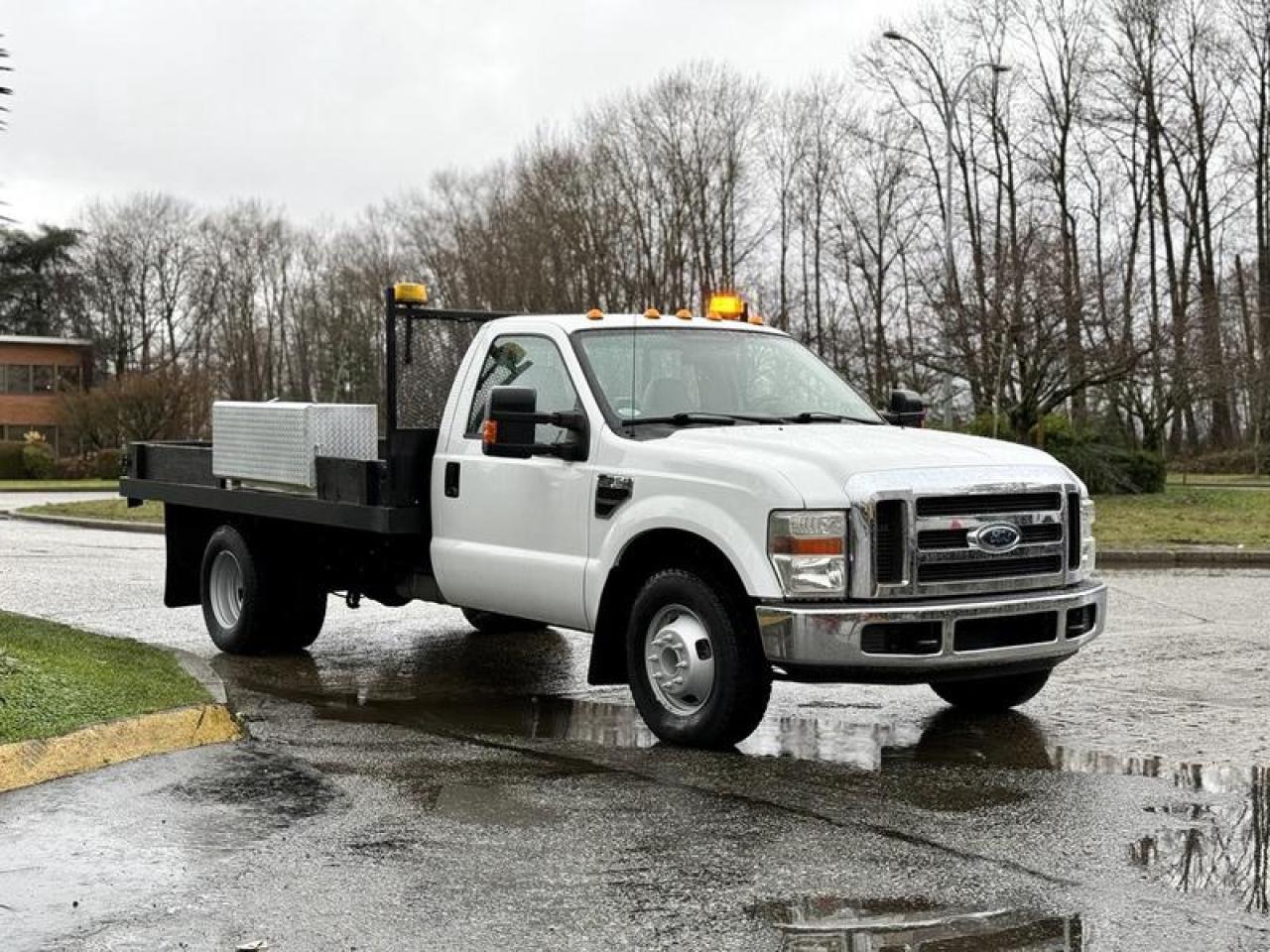 This 2008 Ford F-350 XLT Super Duty flat deck truck is powered by a 5.4L V8 engine paired with an automatic transmission and rear-wheel drive, offering a straightforward work-focused configuration. It is equipped with a 12-foot flat deck measuring approximately 12 ft long and 7 ft 6 in wide, along with a tow package and integrated trailer brake, making it suitable for hauling equipment, materials, or trailers. Features include cruise control, air conditioning and heat, AM/FM radio with CD player, auxiliary switches, beacon light, storage compartment, and power windows, power door locks, and power mirrors. Finished in a white exterior with tan cloth interior, the truck measures approximately 21 ft 9 in long, 7 ft 9 in wide, and 6 ft 9 in high, with a GVWR of 5,897 kg (13,000 lb), positioning it as a practical flat deck platform for general contracting, transport, and fleet use. This item is currently OFFSITE. You must register an appointment with our office to schedule an offsite viewing. Appointments must be made a minimum of one business day in advance (and as defined by the days that Repo.com is open for business) before your appointment can be scheduled and confirmed. We may, at our own discretion, instead opt to transport smaller items to Repo.coms main yard for viewing purposes.  $28,880.00 plus $375 processing fee, $29,255.00 total payment obligation before taxes.  Listing report, warranty, contract commitment cancellation fee, financing available on approved credit (some limitations and exceptions may apply). All above specifications and information is considered to be accurate but is not guaranteed and no opinion or advice is given as to whether this item should be purchased. We do not allow test drives due to theft, fraud, acts of vandalism and undetectable impaired driving. Instead we provide the following benefits: Complimentary Warranty (with options to extend), Limited Money Back Satisfaction Guarantee on Fully Completed Contracts, Contract Commitment Cancellation, and an Open-Ended Sell-Back Option. Ask seller for details or call 604-522-REPO(7376) to confirm listing availability.