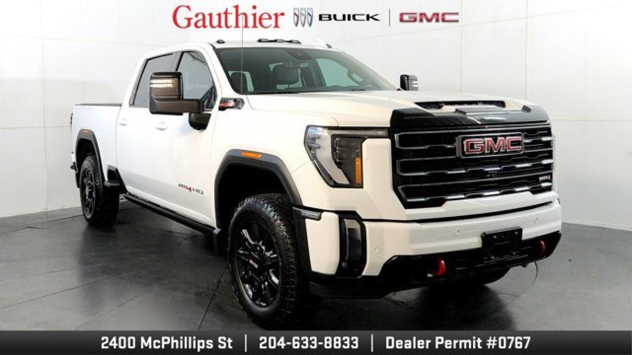 The 2024 GMC Sierra 2500HD AT4 is a rugged, heavy-duty pickup designed for serious off-road capability and worksite toughness, featuring a standard 6.6 L V8 diesel engine paired with an Allison 10-speed automatic transmission for strong performance and towing. Its off-road-ready package includes an AT4-specific suspension with Rancho shocks, skid plates, a rear e-locking differential, and aggressive 20-inch gloss-black wheels while the interior offers Jet Black with Kalahari-accent leather seating thats heated and ventilated for comfort on long hauls. High-tech conveniences like a 13.4-inch touchscreen infotainment system and a 12.3-inch digital driver display complement its rugged capability, making the AT4 a well-rounded choice for both trail adventures and heavy-duty tasks.