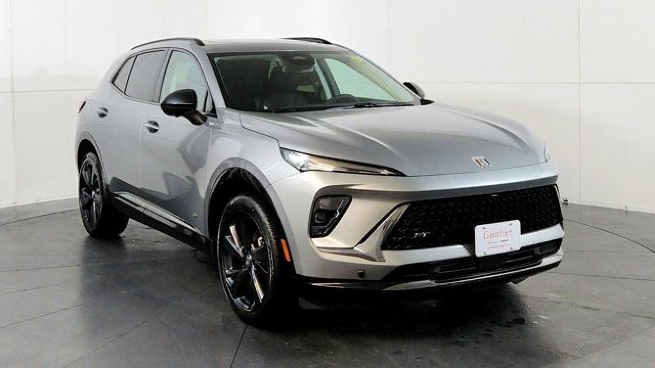 The 2026 Buick Envision Sport Touring delivers athletic styling and premium amenities. Its powered by a 2.0-liter turbocharged 4-cylinder engine paired with a 9-speed automatic transmission and standard all-wheel drive, riding on 20-inch alloy wheels with dark-gloss accents for a more aggressive look. Inside, the cabin features a large 30-inch ultrawide display, heated front seats, a Bose premium sound system, adaptive cruise control, lane-keeping assistance, and a panoramic power moonroof that brings in extra light and openness.