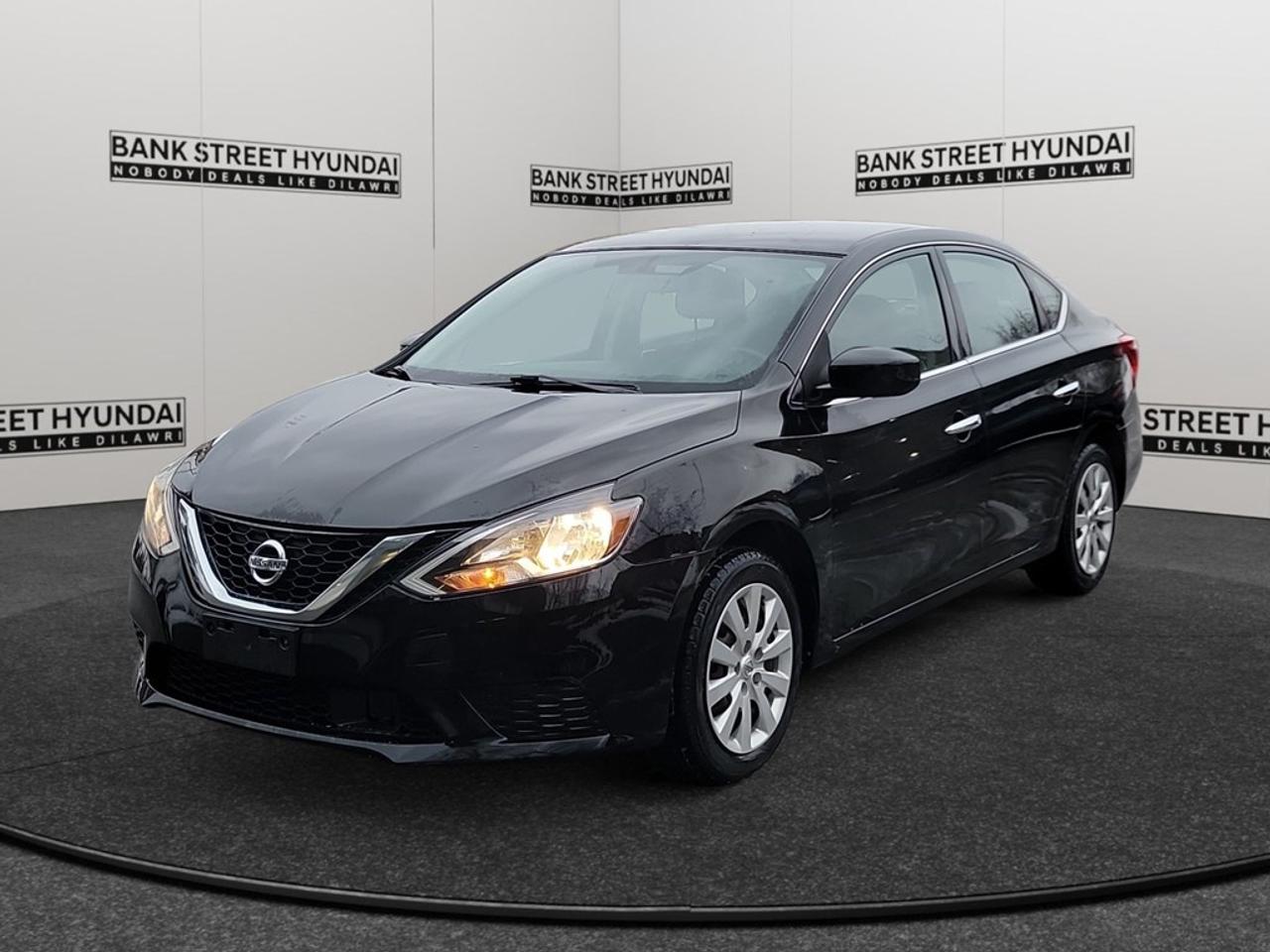 The 2019 Nissan Sentra S CVT in a sophisticated black hue with a front-wheel-drive system offers remarkable handling, making every drive a pleasure. This sedan is designed to impress with its sleek exterior lines that complement its practical and stylish form. Inside, youll find a well-appointed cabin that balances comfort and convenience. With features such as power windows and keyless entry, every journey is made more enjoyable. The backup camera provides an extra layer of confidence when navigating busy city streets or tight parking spaces. Equipped with Bluetooth connectivity for easy access to your favorite tunes and hands-free calling, this Sentra ensures youre always connected. Safety features like brake assist promise peace of mind by enhancing control during sudden stops. The cruise control option adds to the convenience on those long highway journeys. This vehicle is perfect for commuters and small families seeking efficiency, practicality, and a touch of elegance in their everyday travels. Dont miss the opportunity to own this incredible 2019 Nissan Sentra. Contact our dealership today to learn more and schedule a test drive!