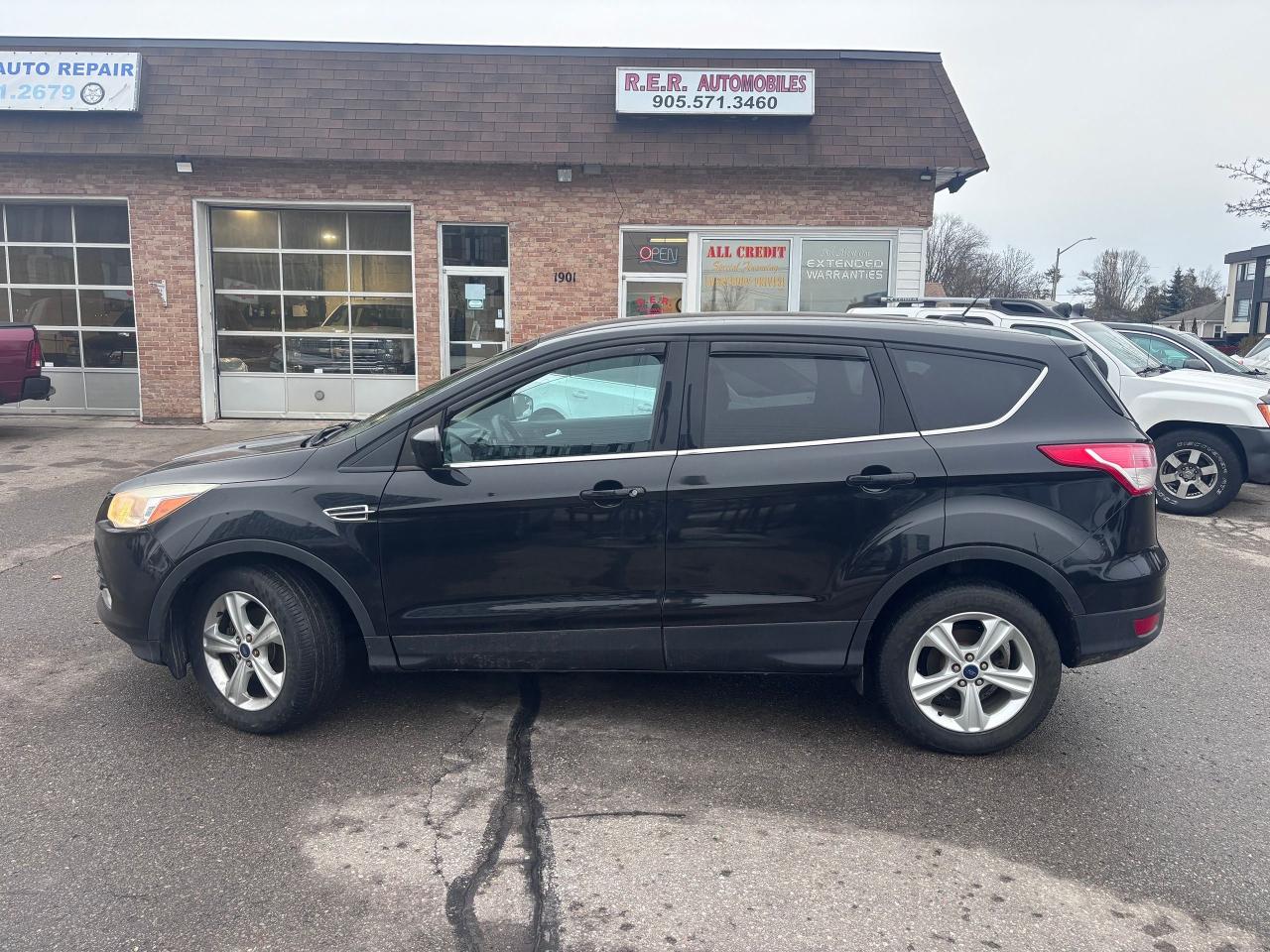 <p>Looking for a reliable and versatile SUV thats perfect for navigating Canadian roads? Check out this sleek 2014 Ford Escape SE, available now at R.E.R. Automobiles Ltd! This black beauty boasts a comfortable grey interior, offering a stylish and practical driving experience. With its efficient 1.6L 4-cylinder turbo engine, youll enjoy a responsive performance without compromising on fuel economy.</p><p>This Escape is a front-wheel-drive SUV with an automatic transmission, making it easy to handle in various driving conditions. It has 185,000 km on the odometer. Its a fantastic option for families, commuters, and anyone seeking a well-rounded vehicle that can handle both city streets and weekend adventures.</p><p>Here are a few features that make this 2014 Ford Escape stand out:</p><ul><li><strong>Turbocharged Engine:</strong> Experience spirited acceleration and impressive fuel efficiency from the peppy 1.6L engine.</li><li><strong>SUV Versatility:</strong> Enjoy the practicality of an SUV, with ample cargo space and comfortable seating for passengers.</li><li><strong>Fuel-Efficient Design:</strong> Save money at the pump with the Escapes fuel-efficient engine.</li><li><strong>Automatic Transmission:</strong> Provides easy and smooth driving in any situation.</li><li><strong>Stylish Design:</strong> Turn heads with its sleek black exterior and comfortable grey interior.</li></ul><p><strong><em>Powered by AutoIntelligence&trade;</em></strong> Vehicle information has been generated using artificial intelligence and is provided for informational purposes only. While efforts are made to ensure accuracy, please confirm all details directly with the dealer.</p><pre style=overflow-wrap: break-word; white-space: pre-wrap;>This vehicle is certified,  serviced & oil changed. Financing available O.A.C  <br><br><br>R.E.R. Automobiles Ltd. is a family owned business, established in 1994.<br><br>Referrals built us, reliability keep us serving you.<br><br>R.E.R. Automobiles Ltd. ... We Care.</pre>