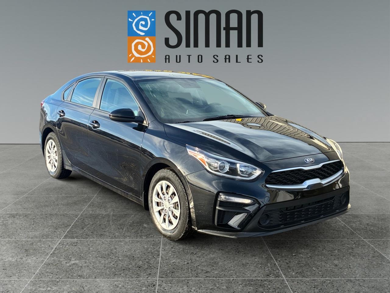 <p>Imagine it&rsquo;s a Monday morning. It&rsquo;s freezing outside, and you&rsquo;re staring down a 40-minute commute across the Saskatchewan prairies. You slide into your&nbsp;<strong>2021 Kia Forte LX</strong>, and within seconds, the&nbsp;<strong>standard heated front seats</strong>&nbsp;have already taken the edge off the cold. You plug in your phone, and your favorite playlist instantly fills the cabin through&nbsp;<strong>Apple CarPlay</strong>, displayed clearly on the&nbsp;<strong>8-inch touchscreen</strong>.&nbsp;</p>

<p>As you hit the highway, you aren't stressing about the rising cost of gas. While other drivers are eyeing the nearest station, you&rsquo;re coasting with a fuel economy that reaches as low as&nbsp;<strong>5.9 L/100 km</strong>. The drive is smooth and responsive, thanks to the&nbsp;<strong>2.0L engine</strong>&nbsp;and Intelligent Variable Transmission that adapts to your style.&nbsp;</p>

<p>When you choose to pick up your Forte from&nbsp;<a href=https://www.simanautosales.com/ target=_blank>Siman Auto Sales</a>&nbsp;in Regina, you aren't just getting a car; you're gaining the&nbsp;<strong>"Siman Advantage"</strong>. This family-run dealership ensures every vehicle undergoes a rigorous&nbsp;<strong>mechanical inspection</strong>&nbsp;at their on-site service department before it ever hits the lot.&nbsp;</p>

<p>Need to stop for groceries on the way home? The trunk offers a massive&nbsp;<strong>434 L of space</strong>&mdash;more than enough for a full week of supplies. You pull into your driveway, guided by the crisp&nbsp;<strong>rearview camera</strong>, feeling relaxed because&nbsp;Siman Auto Sales&nbsp;handled the&nbsp;<a href=https://www.simanautosales.com/financial-services/ target=_blank>on-site financing</a>&mdash;with options for everything from prime bank rates to&nbsp;<strong>guaranteed approval</strong>&mdash;making the entire process stress-free.&nbsp;</p>

<p>The 2021 Forte LX at Siman&rsquo;s isn&rsquo;t just a budget-friendly sedan; it&rsquo;s a daily companion backed by a team that's&nbsp;<strong>"large enough to make a difference, small enough to care"</strong>.&nbsp;</p>

<p>Would you like to start a&nbsp;<strong>secure online finance application</strong>&nbsp;through the&nbsp;<a href=https://www.simanautosales.com/financial-services/apply/ target=_blank>Siman Auto Sales website</a>&nbsp;to see your options?</p>