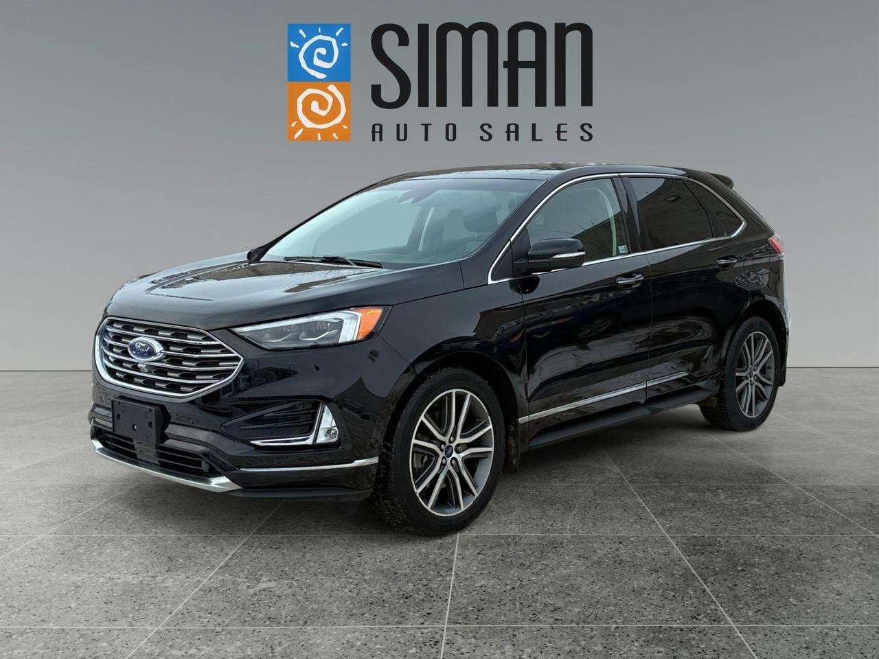 ## **2019 Ford Edge Titanium: Luxury, Technology, and Ultimate Safety**

Experience a premium SUV that refuses to compromise. This 2019 Ford Edge Titanium is a masterpiece of modern driving, combining a sophisticated interior with a suite of high-tech driver-assist features designed to keep you safe and comfortable on Saskatchewan roads.

---

### **Vehicle Overview**

* **Mileage:** 85,000 km
* **History:** Carfax reports no serious collisions
* **Readiness:** Fresh oil service and a complete pre-sale inspection already performed

### **Advanced Safety & Driver Assistance**

This Titanium model is loaded with Ford Co-Pilot360 technology to act as your second set of eyes:

* **Auto Park & Surround Cam:** Let the vehicle help you into tight spots with a 360-degree view.
* **Lane Keep & Blind Spot Detection:** Stay centered and aware of your surroundings at all times.
* **Distance Pace Cruise:** Adaptive cruise control that automatically adjusts your speed to maintain a safe gap from traffic ahead.
* **Auto Headlights & Auto-Dim Mirror:** Intelligent lighting that adapts to your environment for maximum visibility.

### **Premium Comfort & Entertainment**

Step into a cabin designed for the ultimate driving experience:

* **Panoramic Sunroof:** Open up the cabin to beautiful prairie skies.
* **Climate Controlled Seating:** Power memory seats that are both heated and cooled for year-round comfort.
* **Connected Technology:** Navigation, Bluetooth, Sirius Radio, and a CD player for all your media needs.
* **Home Link:** Integrated garage door opener for seamless arrivals.

---

### **The Siman Auto Sales Advantage**

We have been a part of the Saskatchewan community for over 27 years. With over 70 vehicles in stock, we are large enough to make a difference and small enough to care.

* **Flexible On-Site Financing:** We work with 16 banks and lenders to ensure you get the best approval possible.
* **Trades Encouraged:** We want your trade-in and offer competitive values to help you upgrade.
* **Custom Protection:** Aftermarket warranties are available to fit every specific need and budget.
* **Proven Reputation:** Check our reviews to see why our customers keep coming back!