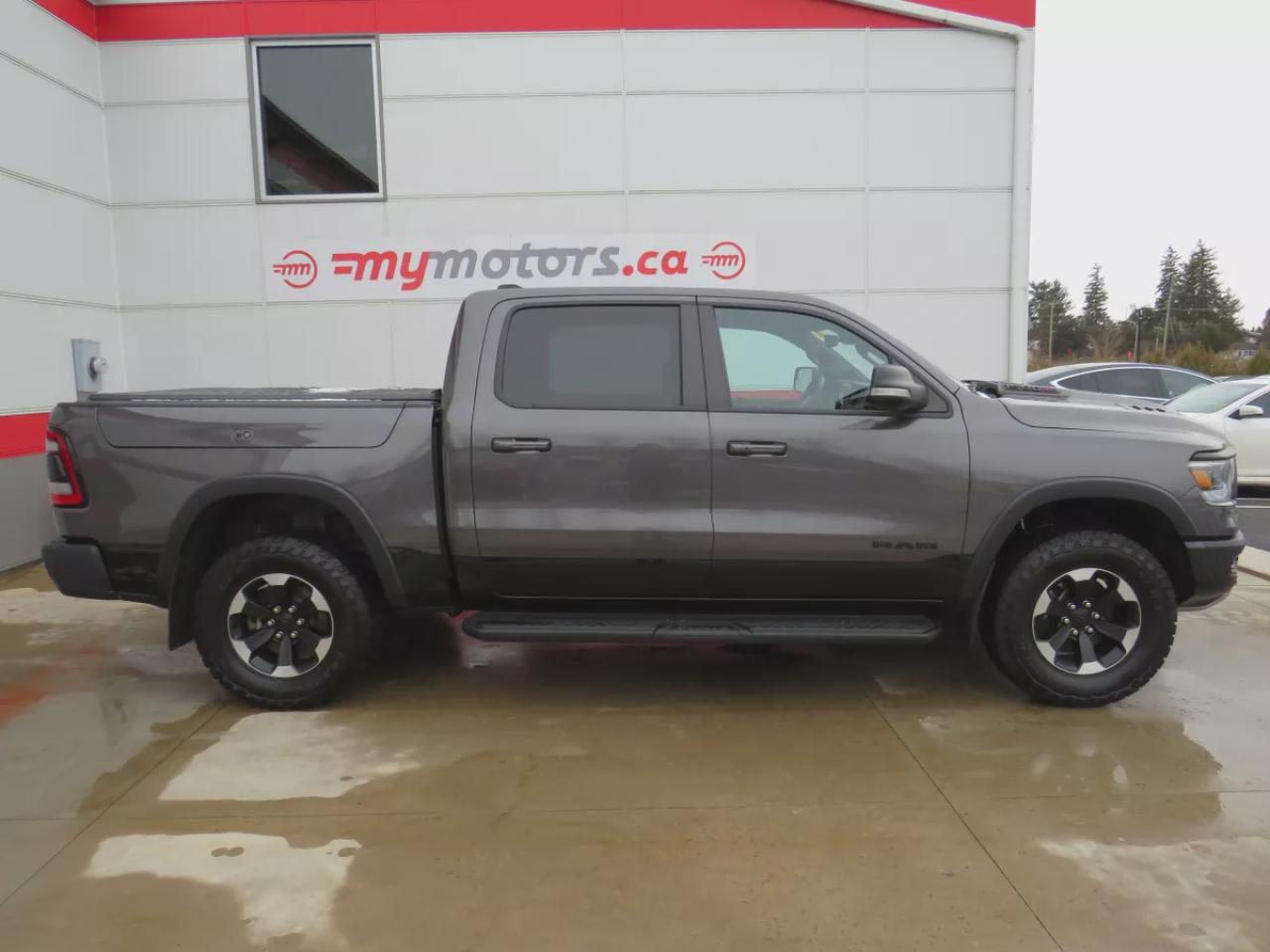 2022 RAM 1500 Rebel (**SAFETY/CERTIFIED!!**4WD**RUNNING BOARDS**TRAILER HITCH**TONNEAU COVER**REMOTE START**BRAKE CONTROLLER**FRONT TOW HOOKS**NAVIGATION**FOG LIGHTS**WIRELESS PHONE CHARGING**HEATED FRONT AND REAR SEATS**REVERSE CAMERA**LEATHER**SUNROOF**PUSH BUTTON ST Photo