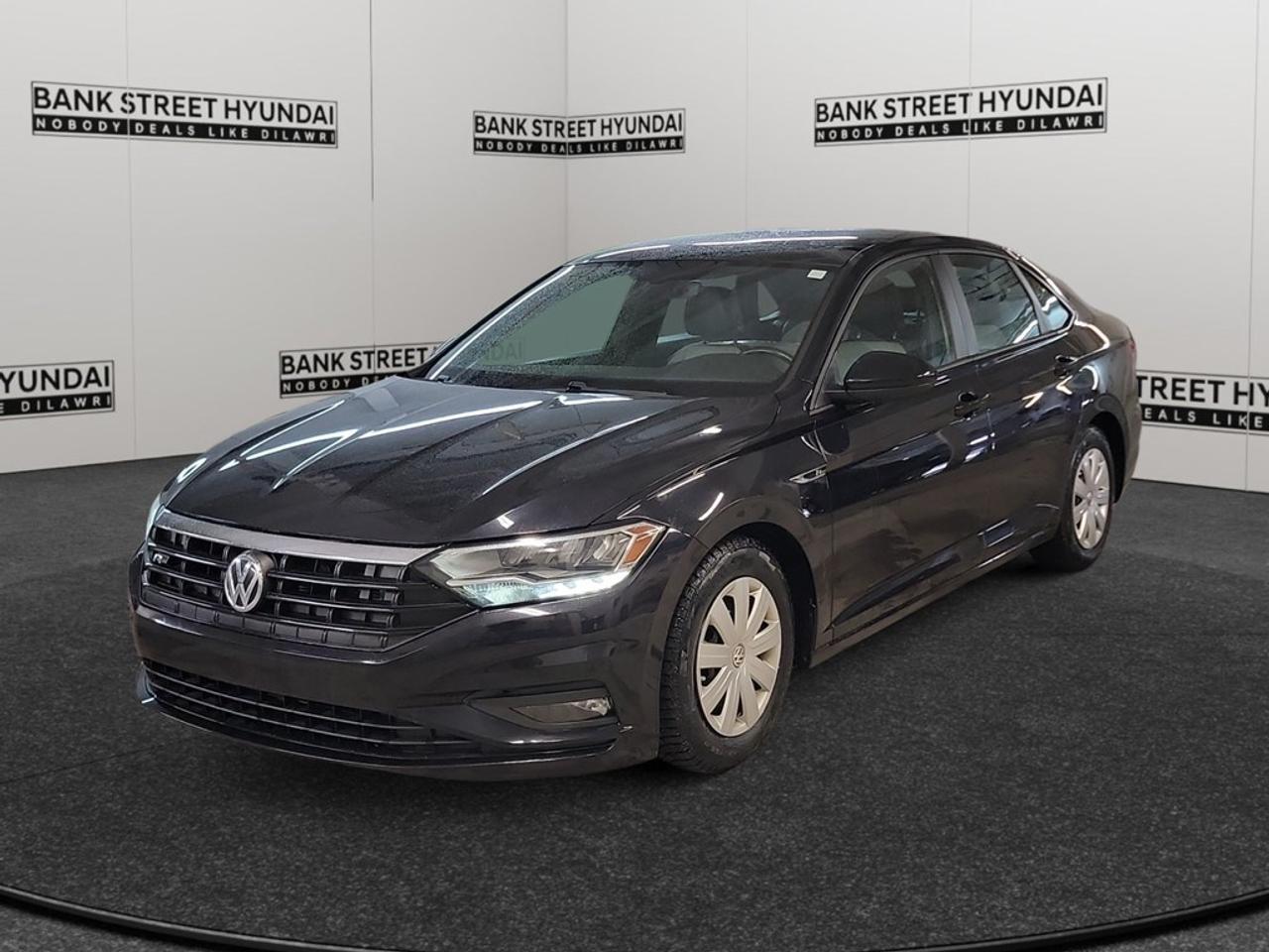 Experience refined driving with the 2019 Volkswagen Jetta Highline in an eye-catching Black exterior. This Front-Wheel Drive (FWD) sedan offers smooth handling complemented by the comfort of its Automatic transmission. The striking exterior of this compact sedan sets the stage with its elegant design, enhanced by alloy wheels and a sunroof/moonroof allowing natural light in. Step inside, and youre greeted by a thoughtful interior where heated seats provide comfort on chilly days. The seats boast Leatherette Back Material, and a Leather/Metal-Look Gear Shifter Material accentuates the stylish cabin. Power windows and a leather steering wheel further enhance the driving experience while the Leatherette Door Trim Insert adds a touch of luxury. This Jetta is equipped with a host of technology features, including a backup camera, Bluetooth connection, and smart device integration, all ensuring youre connected and entertained throughout your journey. Safety is a priority with features like lane assist and brake assist providing peace of mind on every drive. This vehicle is perfect for professionals and small families seeking a reliable yet stylish ride with advanced features. Contact us today to learn more and get behind the wheel of this sophisticated Volkswagen Jetta Highline.