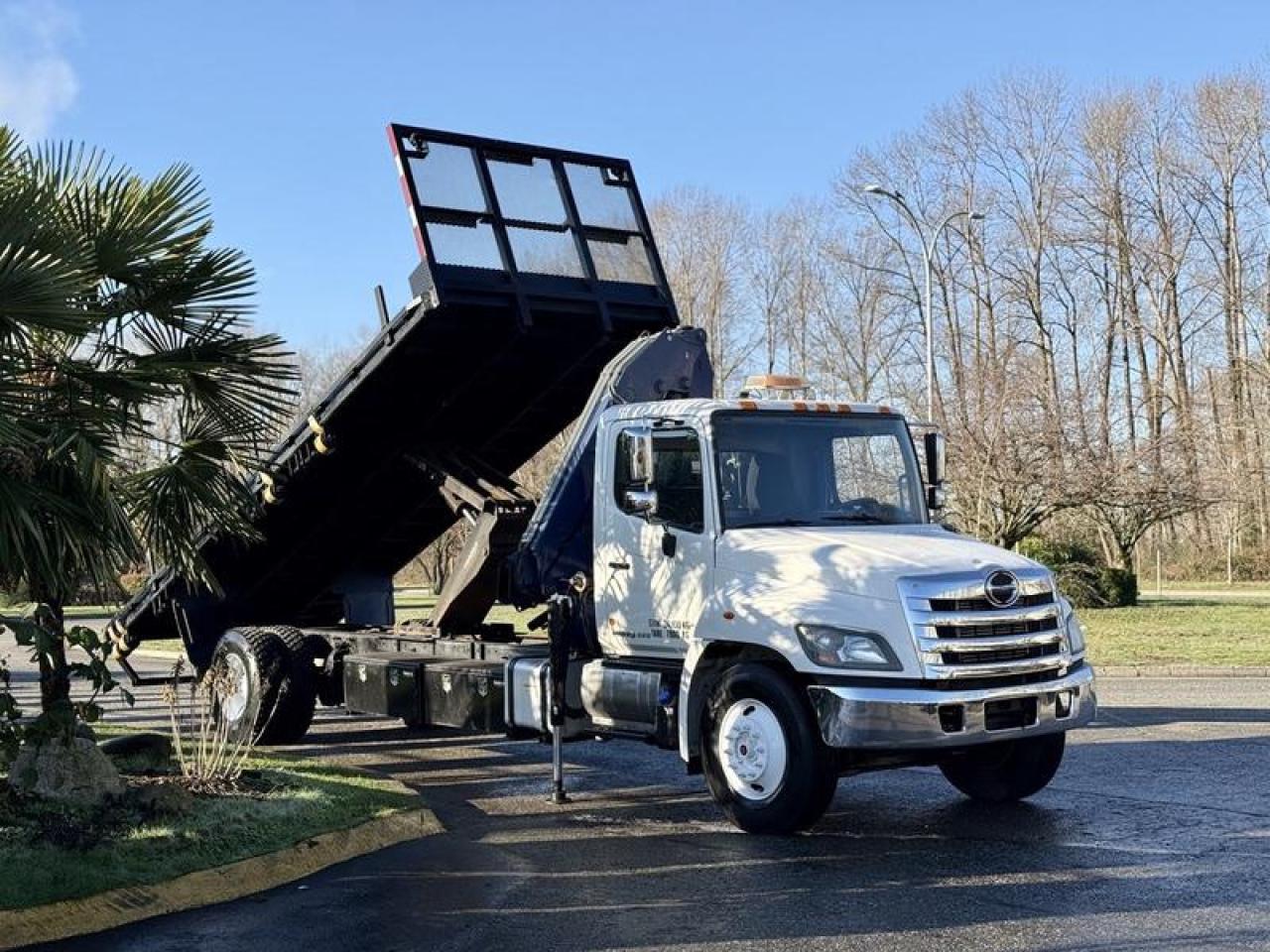 Used 2015 Hino 358 22-Foot Flat Deck Truck with Dump Function and Amco Veba Crane for sale in Burnaby, BC