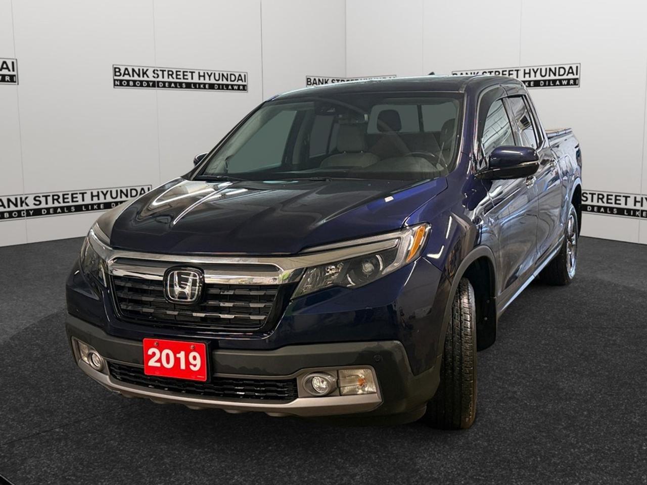The 2019 Honda Ridgeline Touring AWD, presented in a striking blue finish, offers exceptional handling with its all-wheel drive system. This versatile truck is perfect for both city streets and rugged trails. On the outside, the Ridgeline exhibits a commanding yet refined presence, featuring alloy wheels and sleek body lines. Step inside to experience a cabin that perfectly blends functionality with luxury. Leather seats, both heated and cooled, offer supreme comfort, while the sunroof brightens every journey. This truck comes equipped with all the high-tech features youll need. The navigation system and smart device integration ensure youre well-connected. For safety, the Ridgeline packs impressive features such as a backup camera, lane assist, adaptive cruise control, and parking sensors, providing peace of mind on every drive. The 2019 Honda Ridgeline Touring AWD is ideal for those who seek a reliable truck with advanced features for both work and play. Whether youre an adventurer or a family-oriented individual, this truck has everything you need. Contact our dealership today to learn more and to experience this fantastic vehicle for yourself.