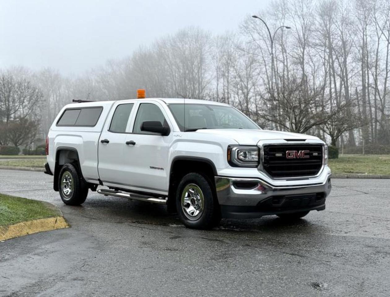 This 2018 GMC Sierra 1500 Double Cab 4x4 is a full-size pickup powered by a 4.3L V6 engine paired with an automatic transmission and four-wheel drive, configured for light-duty commercial and fleet use. It is equipped with a pickup bed fitted with a canopy featuring side windows and a bed liner, providing enclosed rear cargo space suitable for tools, equipment, or materials. Additional equipment includes a traffic control panel, backup camera, cruise control, tow mode, running boards, and power windows, door locks, and mirrors. The interior features air conditioning and heat along with an AM/FM radio with Bluetooth connectivity. Finished in white with a grey cloth interior, this Sierra offers a practical combination of cab space, cargo versatility, and everyday usability. This item is currently OFFSITE. You must register an appointment with our office to schedule an offsite viewing. Appointments must be made a minimum of one business day in advance (and as defined by the days that Repo.com is open for business) before your appointment can be scheduled and confirmed. We may, at our own discretion, instead opt to transport smaller items to Repo.coms main yard for viewing purposes.  $30,720.00 plus $375 processing fee, $31,095.00 total payment obligation before taxes.  Listing report, warranty, contract commitment cancellation fee, financing available on approved credit (some limitations and exceptions may apply). All above specifications and information is considered to be accurate but is not guaranteed and no opinion or advice is given as to whether this item should be purchased. We do not allow test drives due to theft, fraud, acts of vandalism and undetectable impaired driving. Instead we provide the following benefits: Complimentary Warranty (with options to extend), Limited Money Back Satisfaction Guarantee on Fully Completed Contracts, Contract Commitment Cancellation, and an Open-Ended Sell-Back Option. Ask seller for details or call 604-522-REPO(7376) to confirm listing availability.