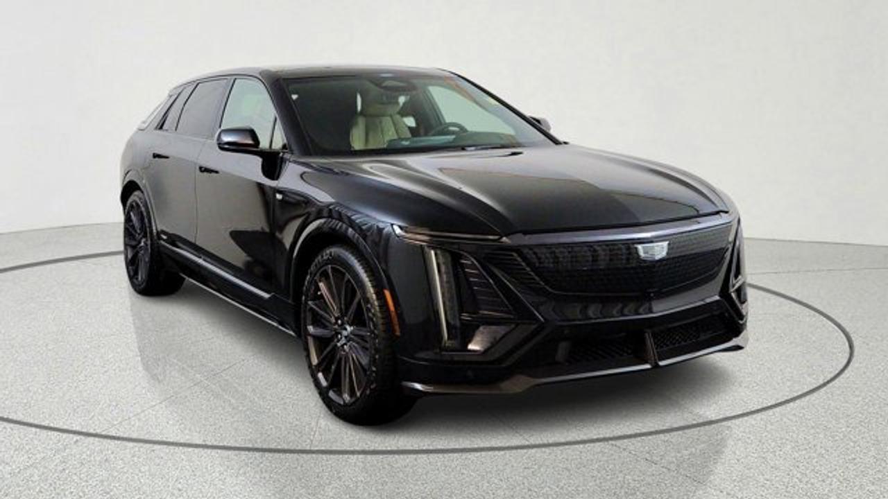 The 2026 Cadillac LYRIQ-V Premium is a high-performance all-electric luxury SUV that combines Cadillacs V-Series sport-tuned dual-motor AWD powertrain with upscale comfort touches like panoramic power-opening sunroof and premium Nappa Leather seating with V-Series embroidery. It offers exhilarating acceleration and dynamic handling thanks to performance-oriented suspension, Brembo brakes, and a high-output battery system, while advanced technology features include a sweeping 33-inch LED display and capability for fast charging. The Premium trim builds on the base LYRIQ-V with enhanced comfort and convenience elements, making it a compelling blend of electric power, tech sophistication and refined interior design.