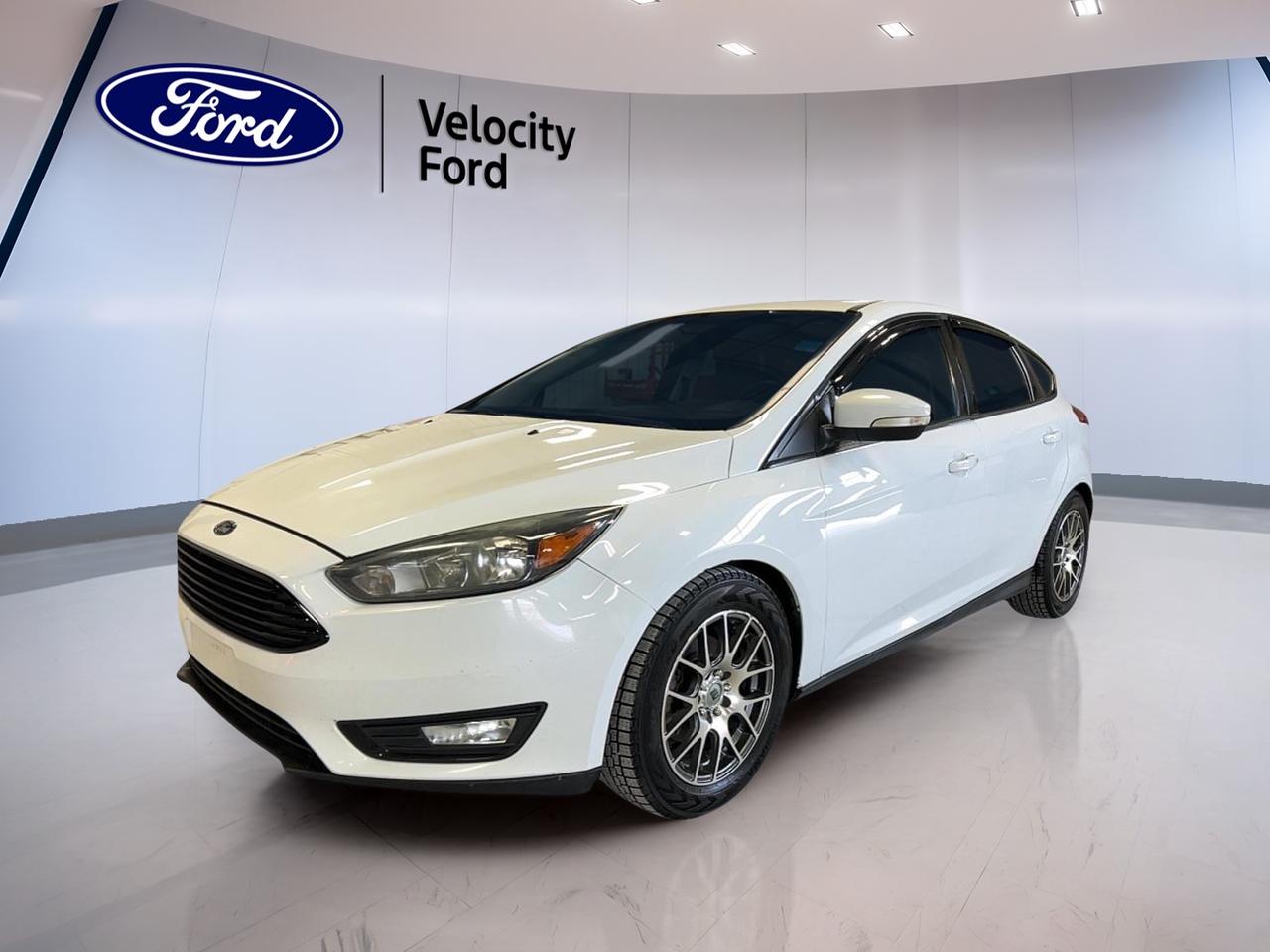 Meet a smart, city-ready hatch that fits life in Moose Jaw. This used 2016 Ford Focus SE Hatchback from Velocity Ford brings a clean White exterior, a Black interior, and the everyday flexibility of a 4-door hatchback. With its 1.0 L gas engine and automatic transmission, its built for easy commuting, quick errands, and weekend plans without feeling bulky.

The 2016 Ford Focus SE Hatchback is a great match for drivers who want a compact footprint with practical features that make daily driving simpler. You get helpful driver-assist basics like a backup camera, plus comfort touches like front air conditioning and cruise control. Add in useful tech like Bluetooth integration and steering wheel audio controls, and youre set up for a confident drive across town or out on the highway.

ADVANCED SAFETY FEATURES  
»» Anti-Lock Braking System for controlled stops  
»» Stability Control helps maintain traction control  
»» Driver airbag and passenger airbag included  
»» Side impact airbags for added protection  

PERFORMANCE AND EFFICIENCY  
»» 1.0 L gas engine for efficiency  
»» Automatic transmission for smooth daily driving  
»» Front-wheel drive for confident road handling  
»» Limited slip differential improves traction grip  

COMFORT AND CONVENIENCE  
»» Front air conditioning for cabin comfort  
»» Cruise control for relaxed highway driving  
»» Power steering for easy low-speed turns  
»» Power windows for quick one-touch control  

TECHNONOLGY AND CONNECTIVITY  
»» Bluetooth integration for hands-free calling  
»» Steering wheel audio controls for convenience  
»» Automatic headlights for better visibility  
»» Ambient lighting package adds cabin glow  

CARGO SPACE  
»» Rear trunk access for easy loading  
»» Cargo cover helps keep items hidden  
»» Rear spoiler adds sporty hatch utility  
»» Spare tire included for roadside readiness  

WHAT OTHER OWNERS LIKE  
»» Easy parking with compact hatch design  
»» Handy backup camera for tight spots  
»» Simple Bluetooth setup for daily calls  
»» Comfortable ride for commuting and errands  

This 2016 Ford Focus SE Hatchbacks VIN is: 1FADP3KE0GL287099.