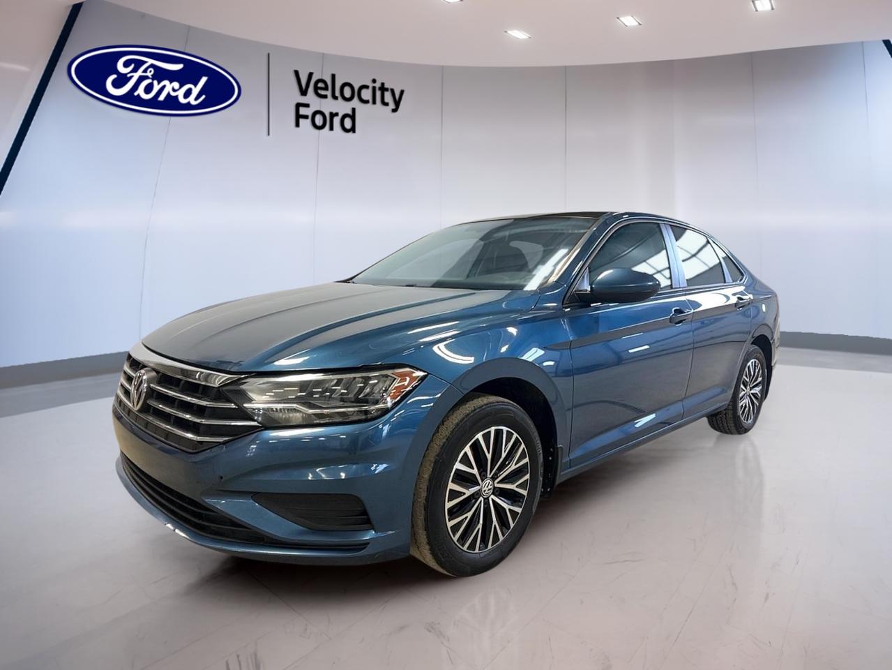 Meet the 2020 Volkswagen Jetta Highline, a smart sedan that fits life in Moose Jaw with ease. Finished in blue with 4 doors, it brings a clean look and a practical footprint for daily driving. This used Jetta Highline pairs a 1.4 L gas engine with an automatic transmission for smooth, simple commuting.

Inside the 2020 Volkswagen Jetta Highline, comfort and control come together in a layout that feels easy from the first kilometer. You get helpful everyday features like power windows, power steering, and cruise control, plus a sunroof that adds light and fresh air to your drive. Dual-zone automatic climate control helps both front occupants stay comfortable in changing Prairie weather.

FEATURES OF THE Jetta Highline  
»» 1.4 L turbo gas, automatic  
»» Dual-zone automatic climate control included  
»» Glass sunroof with push-button start  
»» LED headlamps and ambient lighting  

ADVANCED SAFETY FEATURES  
»» Anti-lock braking system for controlled stops  
»» Stability control helps maintain road grip  
»» Blind spot monitor for safer lane changes  
»» Backup camera for easier reversing  

PERFORMANCE AND EFFICIENCY  
»» 1.4 L gas engine for daily driving  
»» Automatic transmission with dual shift mode  
»» 8-speed automatic supports smooth acceleration  
»» Front-wheel drive for confident city traction  

COMFORT AND CONVENIENCE  
»» Heated front seats for cold mornings  
»» Power windows for quick, easy control  
»» Push button start for fast getaways  
»» Auto-dimming rearview mirror reduces glare  

TECHNONOLGY AND CONNECTIVITY  
»» Bluetooth integration for hands-free calling  
»» Satellite radio for more listening choice  
»» Steering wheel audio controls within reach  
»» Adjustable steering wheel for better fit  

CARGO SPACE  
»» Rear trunk access for easy loading  
»» Sedan trunk suits daily errands well  
»» Spare tire included for added confidence  
»» Four doors simplify passenger entry  

WHAT OTHER OWNERS LIKE  
»» Smooth power delivery in daily traffic  
»» Easy-to-use controls and clear layout  
»» Comfortable ride for longer highway drives  
»» Helpful safety tech for peace of mind  

At Velocity Ford, we like vehicles that make sense for real life, and the 2020 Volkswagen Jetta Highline delivers. From LED headlamps and heated mirrors to child safety locks and a full set of airbags, its built to support your routine without fuss. Add in automatic headlights, a rear window defroster, and tire pressure monitoring, and youre ready for changing seasons in Saskatchewan.

This 2020 Volkswagen Jetta Highlines VIN is: 3VWEB7BU4LM006469.