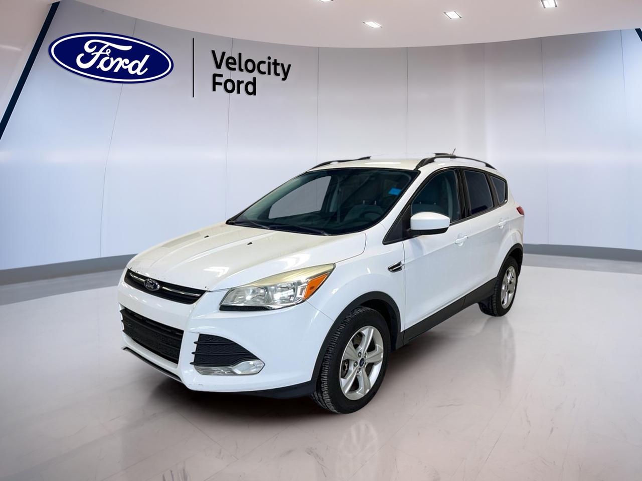 // SINGLE OWNER! //

Meet a smart and capable SUV for life in Moose Jaw. This used 2015 Ford Escape SE 4WD at Velocity Ford comes in clean White with a Brown interior and 4 doors for easy daily access. It is powered by a 2.0 L gas engine and an automatic transmission for smooth, simple driving. CARFAX Canada reports this Escape has had a single owner, which is a great sign of consistent care. The odometer shows km.

FEATURES OF THE Escape SE 4WD
»» 4WD traction for changing road conditions  
»» 2.0 L gas engine power  
»» 6-speed automatic with dual shift  
»» Backup camera for easier parking  

ADVANCED SAFETY FEATURES
»» Anti-lock braking system helps maintain control  
»» Stability control supports confident cornering  
»» Side impact airbags add protection  
»» Child safety locks for rear doors  

PERFORMANCE AND EFFICIENCY
»» 2.0 L gas engine for passing  
»» Four-wheel drive for added grip  
»» 6-speed automatic transmission shifts smoothly  
»» Limited slip differential aids slippery traction  

COMFORT AND CONVENIENCE
»» Heated front seats for cold mornings  
»» Front air conditioning keeps cabin comfortable  
»» Cruise control reduces highway fatigue  
»» Power windows and power steering  

TECHNONOLGY AND CONNECTIVITY
»» Bluetooth integration for hands-free calling  
»» Steering wheel audio controls included  
»» Satellite radio for more listening choice  
»» Backup camera view aids tight spots  

CARGO SPACE
»» Rear trunk access makes loading easier  
»» Spare tire onboard for peace of mind  
»» Four doors simplify passenger loading  
»» Tinted windows help protect interior  

WHAT OTHER OWNERS LIKE
»» Confident feel from four-wheel drive  
»» Easy parking with backup camera  
»» Comfortable ride with heated seats  
»» Simple controls and Bluetooth pairing  

This 2015 Ford Escape SE 4WDs VIN is: 1FMCU9G91FUA00192.