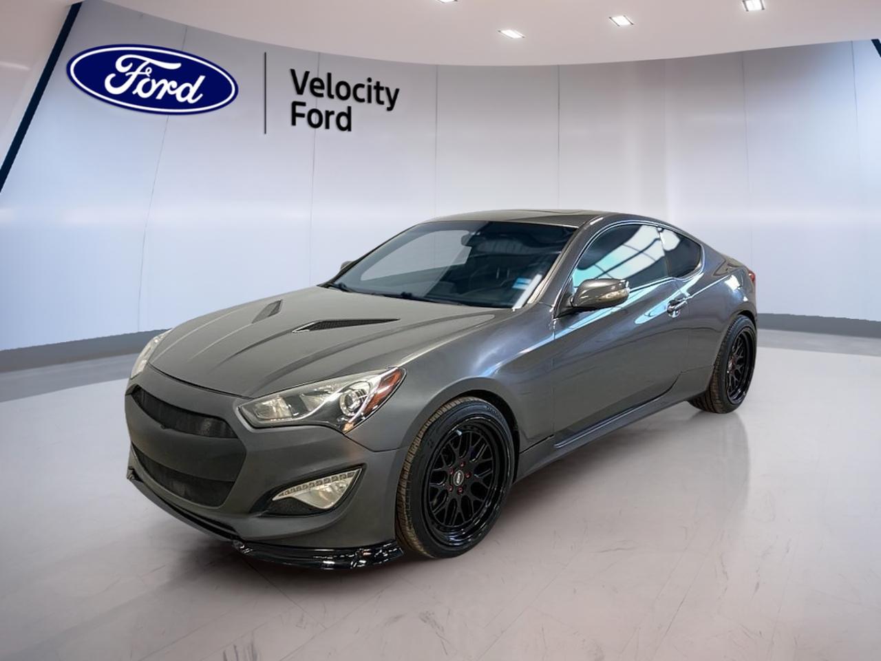 Meet the 2014 Hyundai Genesis Coupe Premium, now available at Velocity Ford in Moose Jaw. Finished in Grey with a Black interior, this 2-door coupe delivers a sporty feel with everyday comfort. With a 2.0 L gas engine and an 8-speed automatic transmission, its built for smooth power and easy cruising.

Inside, the 2014 Hyundai Genesis Coupe Premium keeps the drive simple and driver-focused. You get push button start for quick getaways, plus automatic climate control to help keep the cabin comfortable in changing Prairie weather. Heated front seats and a power drivers seat with lumbar support add comfort for longer drives.

For daily use, this 2014 Hyundai Genesis Coupe Premium adds the convenience features you want most. Cruise control helps on highway runs, while power windows, power steering, and remote trunk release make errands easier. The sunroof brings in extra light and fresh air, and fog lights help when visibility drops.

Safety and confidence matter, and this 2014 Hyundai Genesis Coupe Premium includes key protection features. Anti-Lock Braking System (ABS) and stability control help you stay composed in tough conditions. Driver and passenger airbags, side impact airbags, and a passenger airbag sensor add another layer of support for peace of mind.

Tech is also well covered in this 2014 Hyundai Genesis Coupe Premium. Bluetooth integration helps you stay connected, while steering wheel audio controls keep key functions close at hand. You also get satellite radio, HD Radio, and a navigation system (GPS) to help guide your next trip. A backup camera makes parking and reversing more comfortable in tight spots.

FEATURES OF THE Genesis Coupe Premium
»» 2.0 L gas turbocharged performance feel  
»» 8-speed automatic with dual shift  
»» Navigation system with backup camera  
»» Sunroof plus heated front seats  

ADVANCED SAFETY FEATURES
»» Anti-Lock Braking System for controlled stops  
»» Stability control helps maintain traction  
»» Side impact airbags for added protection  
»» Backup camera for safer reversing  

PERFORMANCE AND EFFICIENCY
»» 2.0 L gas engine for punch  
»» 8-speed automatic transmission for smooth shifts  
»» Dual shift mode for manual-style control  
»» Performance tires for confident road grip  

COMFORT AND CONVENIENCE
»» Automatic climate control for steady cabin comfort  
»» Heated front seats for cold mornings  
»» Power driver seat with lumbar support  
»» Sunroof for extra light and air  

TECHNONOLGY AND CONNECTIVITY
»» Bluetooth integration for hands-free calling  
»» Navigation system helps plan every route  
»» Satellite radio and HD Radio included  
»» Steering wheel audio controls for ease  

CARGO SPACE
»» Remote trunk release for quick access  
»» Trunk space suits daily essentials  
»» Spare tire included for added readiness  
»» Coupe layout keeps gear secure  

WHAT OTHER OWNERS LIKE
»» Smooth shifting 8-speed automatic transmission  
»» Sporty handling with performance tire grip  
»» Useful tech like navigation and Bluetooth  
»» Comfort features like heated front seats  

This 2014 Hyundai Genesis Coupe Premiums VIN is: KMHHT6KD9EU115799.