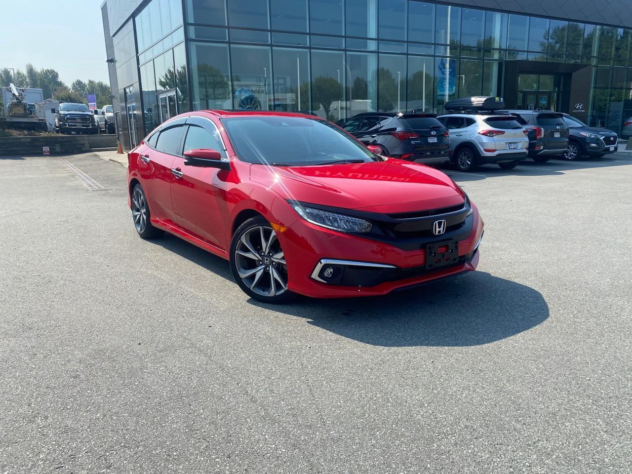 <p><strong>This used 2019 Honda Civic Sedan Touring CVT </strong>delivers premium comfort, advanced technology, and the refined driving dynamics that have made the Civic one of the most trusted sedans on the road. <strong>This used 2019 Honda Civic Sedan </strong><span style=color:rgb( 0 , 0 , 0 )>is available now at </span><strong>Abbotsford Hyundai</strong><span style=color:rgb( 0 , 0 , 0 )>, your trusted dealership in </span><strong>Abbotsford, British Columbia</strong><span style=color:rgb( 0 , 0 , 0 )>.</span></p><p>It offers smooth, responsive performance and excellent fuel efficiency, making it ideal for both city commuting and longer highway trips. The <strong>CVT transmission</strong> keeps the drive quiet and seamless, enhancing overall comfort.</p><p>As the top trim, the <strong>Touring</strong> model is fully loaded with upscale features. Inside, youll find <strong>leather-trimmed seating</strong>, <strong>heated front and rear seats</strong>, a <strong>power drivers seat</strong>, and a <strong>premium audio system</strong>. The cabin feels modern and refined, highlighted by a <strong>7-inch touchscreen</strong> with <strong>navigation</strong>, <strong>Apple CarPlay</strong>, <strong>Android Auto</strong>, Bluetooth, and a multi-angle <strong>rearview camera</strong>. Additional conveniences like <strong>remote start</strong>, <strong>proximity key entry</strong>, and <strong>dual-zone climate control</strong> elevate everyday driving.</p><p>Safety is a major strength, thanks to <strong>Honda Sensing</strong>, which includes <strong>Adaptive Cruise Control</strong>, <strong>Lane Keeping Assist</strong>, <strong>Collision Mitigation Braking</strong>, and <strong>Road Departure Mitigation</strong>. LED headlights, rain-sensing wipers, and front/rear parking sensors add even more confidence on the road.</p><p>Stylish, efficient, and exceptionally well-equipped, the 2019 Honda Civic Touring CVT is an outstanding choice for drivers seeking a reliable sedan with premium features and long-term value. <span style=color:rgb( 0 , 0 , 0 )>This vehicle has undergone a </span><strong>comprehensive multi-point inspection</strong><span style=color:rgb( 0 , 0 , 0 )>by our certified technicians. Ask us about </span><strong>extended warranty options</strong><span style=color:rgb( 0 , 0 , 0 )>, </span><strong>vehicle history reports</strong><span style=color:rgb( 0 , 0 , 0 )>, and </span><strong>flexible financing plans</strong><span style=color:rgb( 0 , 0 , 0 )>tailored to your needs.</span></p> <p>All Abbotsford Hyundai pre-owned vehicles come complete with the remaining Manufacturers Warranty plus a vehicle safety report and a CarFax history report. Abbotsford Hyundai is a BBB accredited pre-owned car dealership, serving the Fraser Valley and our friends in Surrey, Langley and surrounding Lower Mainland areas. We are your Friendly Fraser Valley car dealer. We are located at 30250 Automall Drive in Abbotsford. Call or email us to schedule a test drive.</p><p>*All Sales are subject to Taxes, $799 Doc fee, $87 Fuel Surcharge and up to $1,299 Hyundai Certified Fee for CPO vehicles. Advertised price is finance price, cash price may differ. Refer to dealer website for most up to date information.</p>
