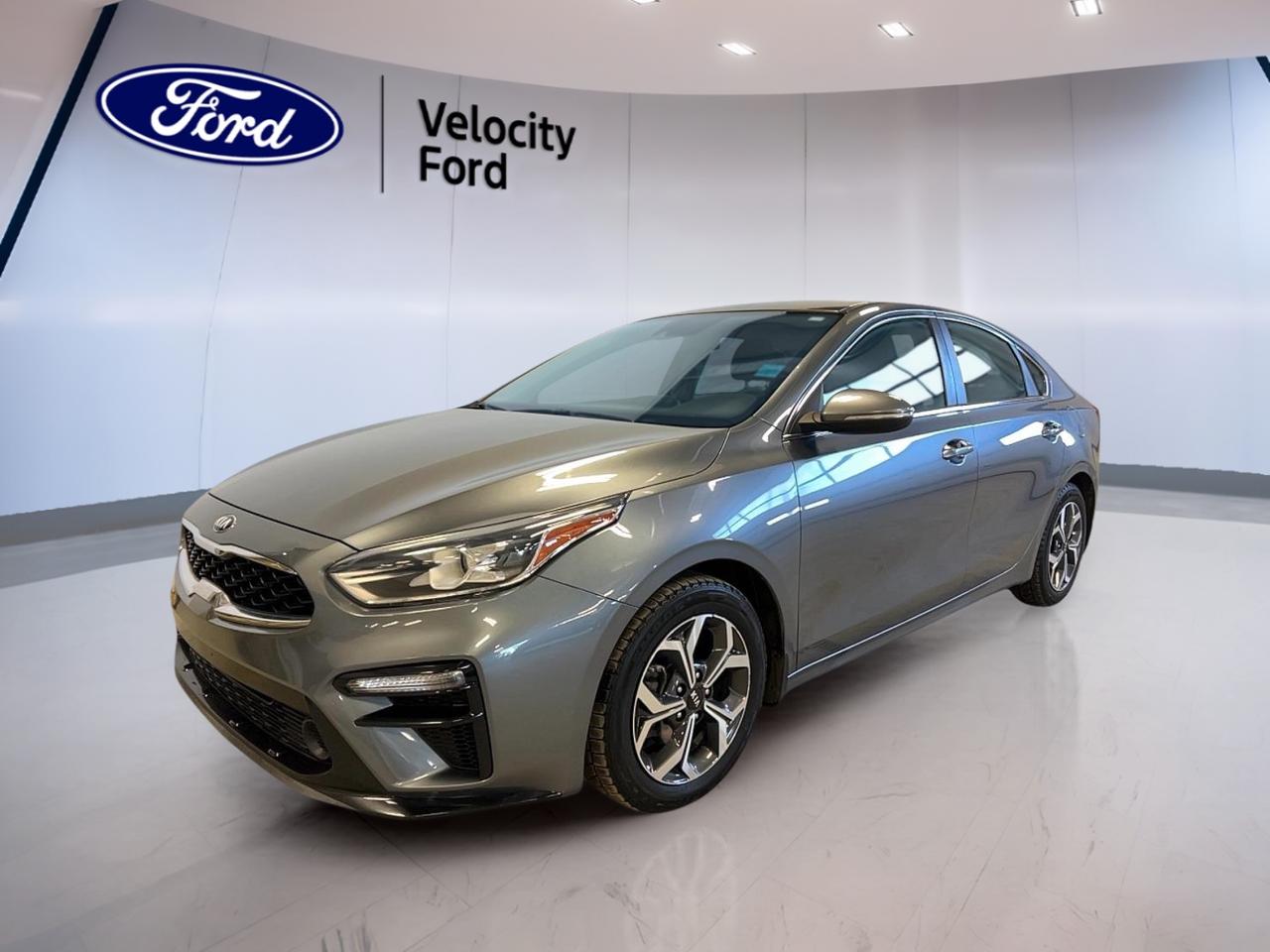 Meet a smart, practical compact sedan that fits Canadian life with ease. This used 2019 Kia Forte EX IVT in Grey with a Black interior is sold by Velocity Ford in Moose Jaw, and it has 56,868 km. With 4 doors, a 2.0 L gas engine, and an automatic transmission, its ready for daily commuting, errands, and weekend drives.

The 2019 Kia Forte EX IVT keeps things simple and confidence-inspiring. You get a clean, modern cabin layout, helpful driver-assist tech, and comfort features that matter when the temperature drops. Add in a roomy trunk, easy-to-use controls, and smooth CVT operation, and you have a sedan that makes everyday driving feel easy.

FEATURES OF THE Forte EX IVT  
»» 2.0 L gas four-cylinder engine  
»» Continuously variable automatic transmission  
»» Heated front seats for cold mornings  
»» Blind spot monitor for safer lane changes  

ADVANCED SAFETY FEATURES  
»» Anti-lock braking system for controlled stops  
»» Stability control for confident handling  
»» Lane departure warning for added awareness  
»» Side impact airbags for occupant protection  

PERFORMANCE AND EFFICIENCY  
»» 2.0 L gas engine, everyday responsive power  
»» CVT automatic for smooth city driving  
»» Front-wheel drive for predictable road manners  
»» Power steering for easy low-speed turns  

COMFORT AND CONVENIENCE  
»» Front air conditioning for cabin comfort  
»» Heated front seats for winter commutes  
»» Power windows for quick adjustments  
»» Remote trunk release for easy loading  

TECHNONOLGY AND CONNECTIVITY  
»» Bluetooth integration for hands-free calling  
»» Steering wheel audio controls within reach  
»» Backup camera for easier reversing  
»» Ambient lighting package for cabin mood  

CARGO SPACE  
»» Rear trunk access for longer items  
»» Spacious trunk for daily hauling  
»» Four-door access for easier loading  
»» Remote trunk release adds convenience  

WHAT OTHER OWNERS LIKE  
»» Smooth CVT feel in traffic  
»» Helpful blind spot monitoring support  
»» Heated seats for Canadian winters  
»» Easy Bluetooth pairing and daily use  

This 2019 Kia Forte EX IVTs VIN is: 3KPF54AD3KE100611.