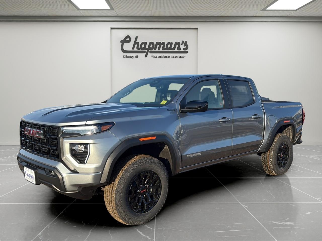 <p>Bold design meets midsize truck capability in this <strong>2026 GMC Canyon Elevation Crew Cab 4WD</strong>, finished in <strong>Sterling Metallic with a Jet Black interior</strong>. Powered by the <strong>2.7L TurboMax engine paired with an 8-speed automatic transmission</strong>, this Canyon delivers strong performance, impressive torque, and confident capability whether you're heading to the jobsite or the trail.</p><p>With a <strong>factory-installed 2-inch lift, widened track, and off-road suspension</strong>, the Canyon Elevation is built to handle rough terrain while maintaining the comfort and refinement expected from GMC. The <strong>auto-locking rear differential and selectable drive modes including Off-Road, Terrain, Tow/Haul, and Normal</strong> allow you to tailor performance to changing road conditions.</p><h3><strong>Performance & Capability</strong></h3><p>Engineered to deliver confident power and off-road capability.</p><ul><li><p>2.7L TurboMax Engine</p></li><li><p>8-Speed Automatic Transmission</p></li><li><p>4WD with Autotrac Electronic Transfer Case</p></li><li><p>Factory 2" Suspension Lift with Widened Track</p></li><li><p>Auto-Locking Rear Differential</p></li><li><p>Driver Mode Selector (Off-Road, Terrain, Tow/Haul & Normal)</p></li><li><p>Stabilitrak with Trailer Sway Control</p></li><li><p>Hill Start Assist</p></li></ul><h3><strong>Interior Comfort & Convenience</strong></h3><p>Smartly designed interior with comfort upgrades.</p><ul><li><p>Heated Front Seats</p></li><li><p>8-Way Power Driver Seat</p></li><li><p>Power Driver Lumbar Support</p></li><li><p>Dual-Zone Automatic Climate Control</p></li><li><p>Remote Vehicle Start</p></li><li><p>Tilt & Telescoping Steering Column</p></li><li><p>Sliding Rear Window</p></li><li><p>Rear 60/40 Folding Bench Seat with Storage</p></li></ul><h3><strong>Technology & Connectivity</strong></h3><p>Modern tech designed to keep you connected on every drive.</p><ul><li><p>11.3" GMC Premium Infotainment Touchscreen with Google Built-In</p></li><li><p>Wireless Apple CarPlay</p></li><li><p>Wireless Android Auto</p></li><li><p>11" Digital Driver Information Centre</p></li><li><p>SiriusXM Radio</p></li><li><p>OnStar Basics (up to 8 years)</p></li><li><p>Multiple USB Ports</p></li></ul><h3><strong>Utility & Exterior Features</strong></h3><p>Practical features that make work and recreation easier.</p><ul><li><p>MultiStow Tailgate</p></li><li><p>EZ-Lift & Lower Tailgate</p></li><li><p>Spray-On Bedliner</p></li><li><p>120V Bed-Mounted Power Outlet</p></li><li><p>18" Gloss Black Aluminum Wheels</p></li><li><p>All-Terrain Tires</p></li><li><p>LED Headlamps & LED Daytime Running Lamps</p></li><li><p>CornerStep Rear Bumper</p></li><li><p>Front Recovery Hooks</p></li></ul><h3><strong>Safety & Driver Assistance</strong></h3><p>Confidence comes standard with GMC safety technology.</p><ul><li><p>Automatic Emergency Braking</p></li><li><p>Forward Collision Alert</p></li><li><p>Lane Keep Assist with Lane Departure Warning</p></li><li><p>Front Pedestrian & Bicyclist Braking</p></li></ul><p>With bold styling, modern technology, and off-road-ready engineering, this <strong>2026 GMC Canyon Elevation Crew Cab 4WD</strong> delivers the perfect balance of midsize maneuverability and serious truck capability. Whether you're tackling tough terrain, hauling gear, or commuting in comfort, this Canyon is ready for it all.</p><p>2 Year/24,000 kilometer* Complimentary Oil Changes (2 total)</p><p>3 Year/60,000 kilometer* Base Warranty Coverage</p><p>5 Year/100,000 kilometer* Powertrain Component Warranty Coverage</p><p>5 Year/100,000 kilometer* Courtesy Transportation and 24/7 Roadside Assistance</p><p>6 Year/160,000 kilometer* Sheet Metal (Rust Through) Perforation Warranty Coverage</p><p>*Whichever Comes First.</p><p>Price Includes Dealer Fee.</p><p>Price Excludes PST & GST.</p><p>Financing Options Available, Call For More Details.</p> <p><strong>*While every reasonable effort is made to ensure the accuracy of this information, we are not responsible for any error or omissions contained on these pages. Please verify any information in question with Chapman Motors Ltd.</strong></p>